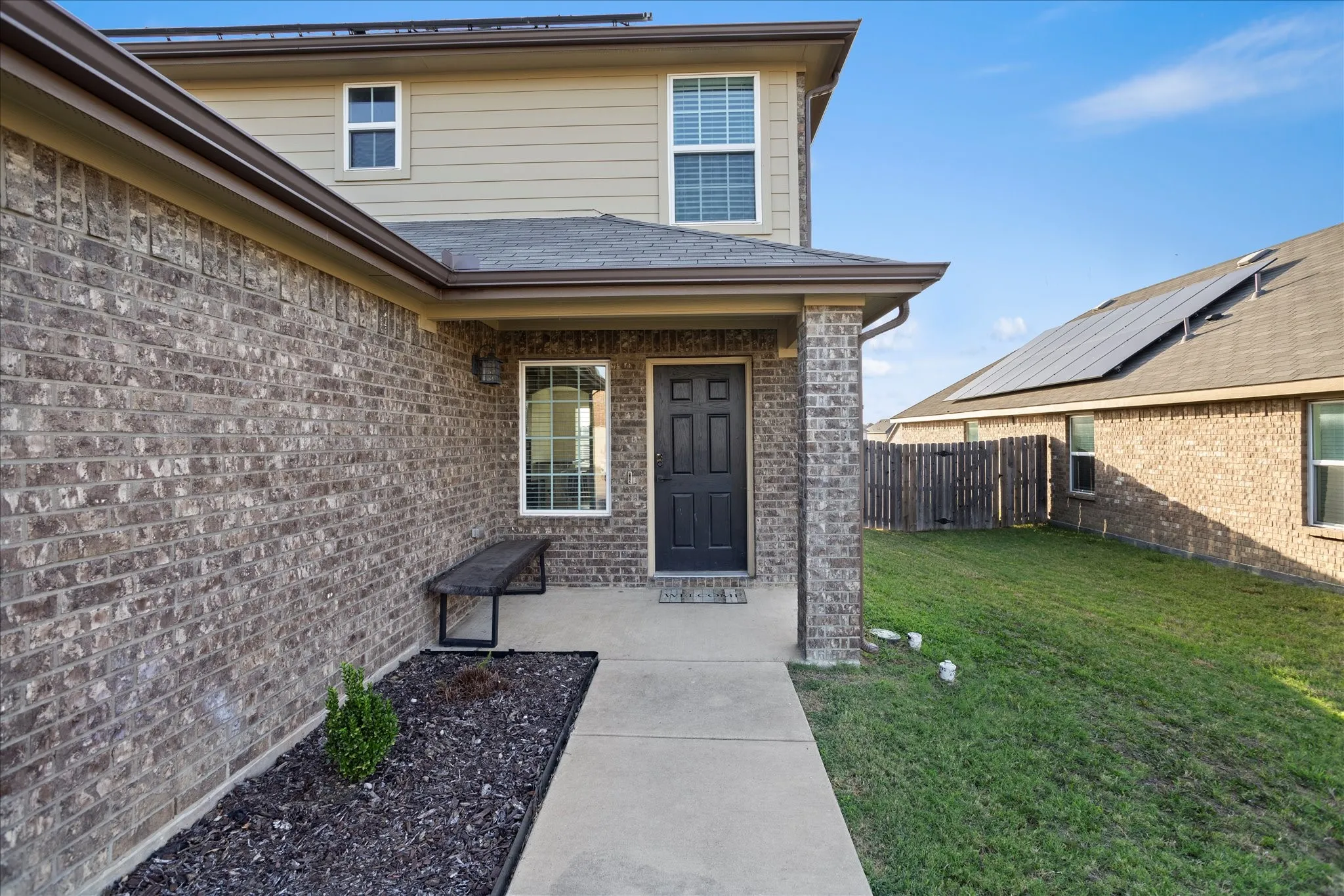 Brick and siding exterior with a covered front entry