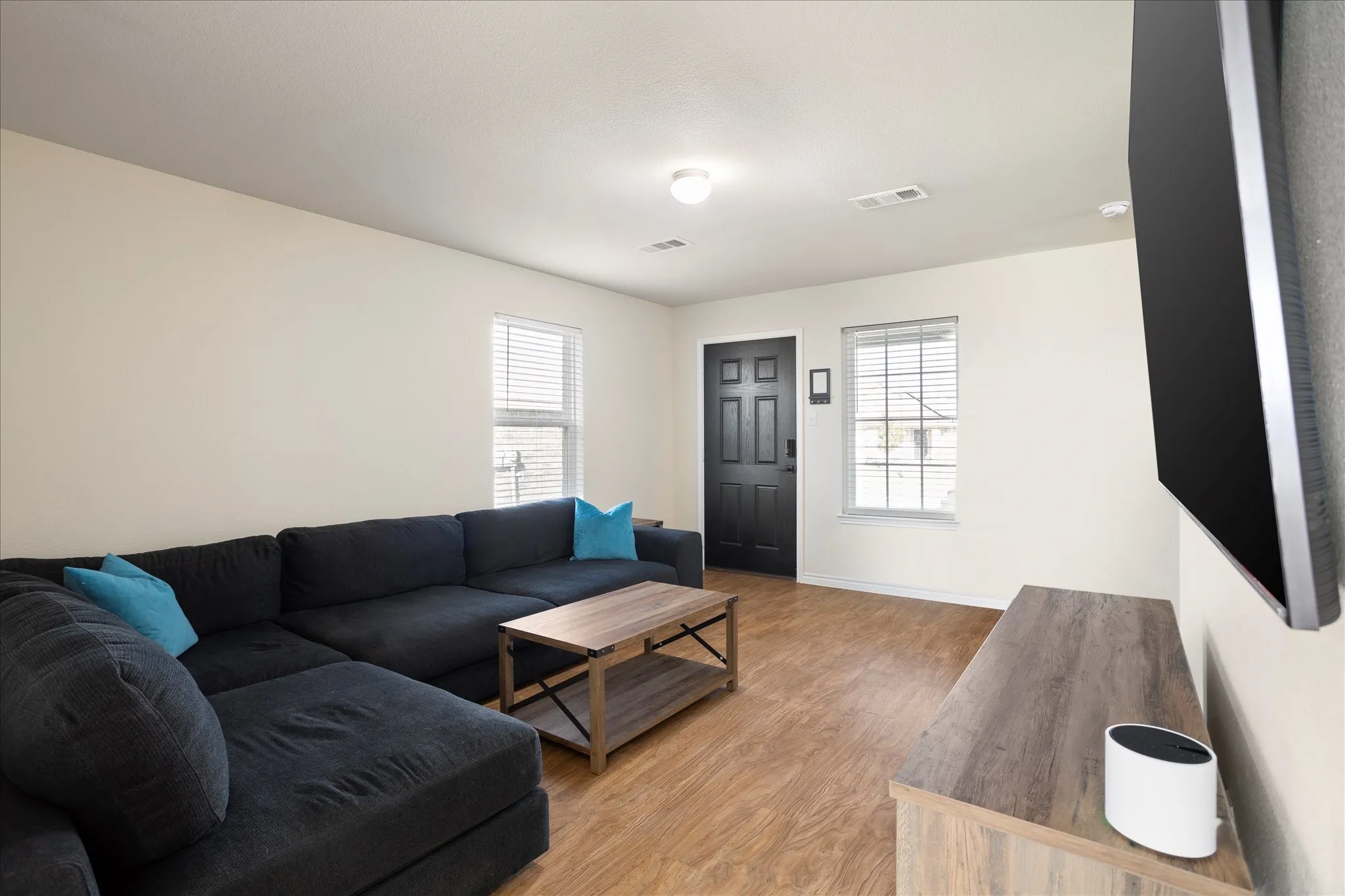 Wood-finish flooring, white walls, and white trim