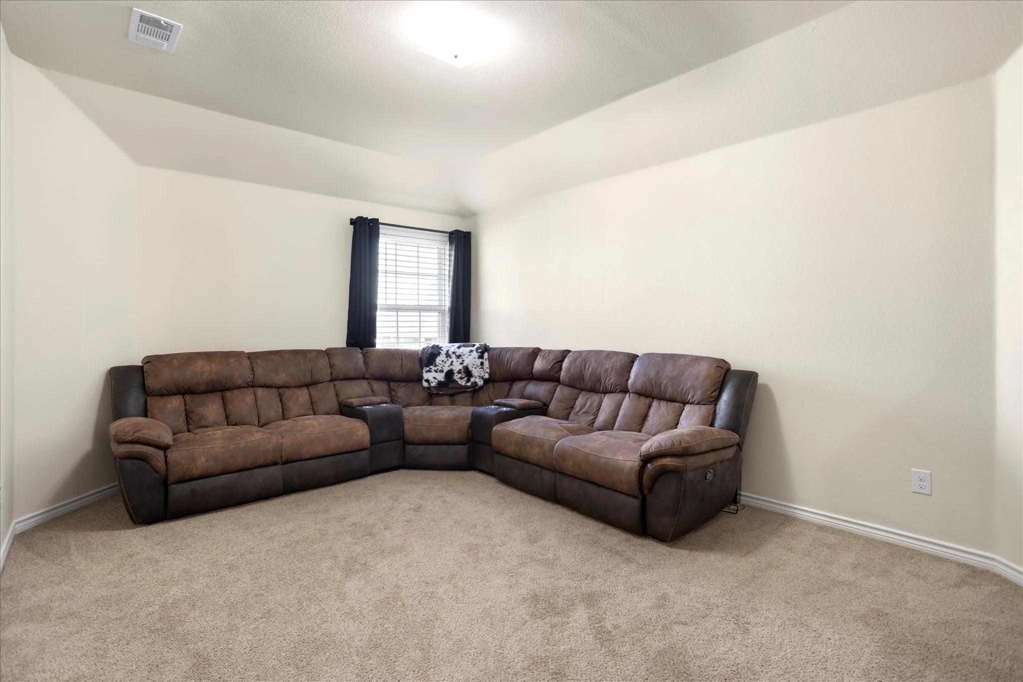 Carpeted flooring, neutral wall tones, window with horizontal blinds, recessed lighting