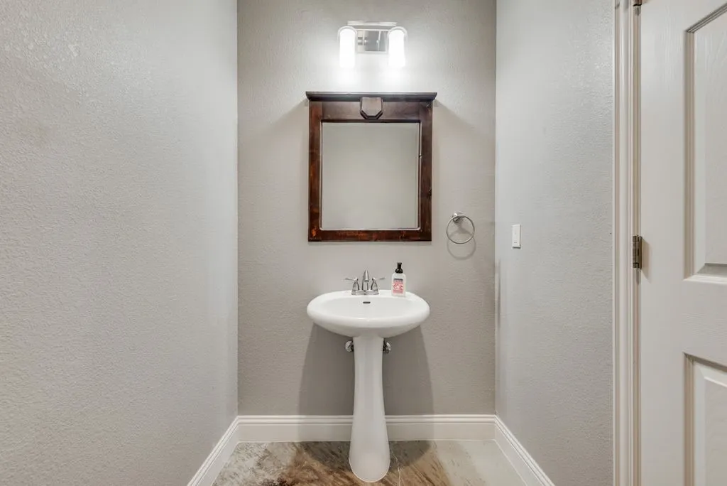 This half bath is off of the main living space and has quick access to the back patio and pool.