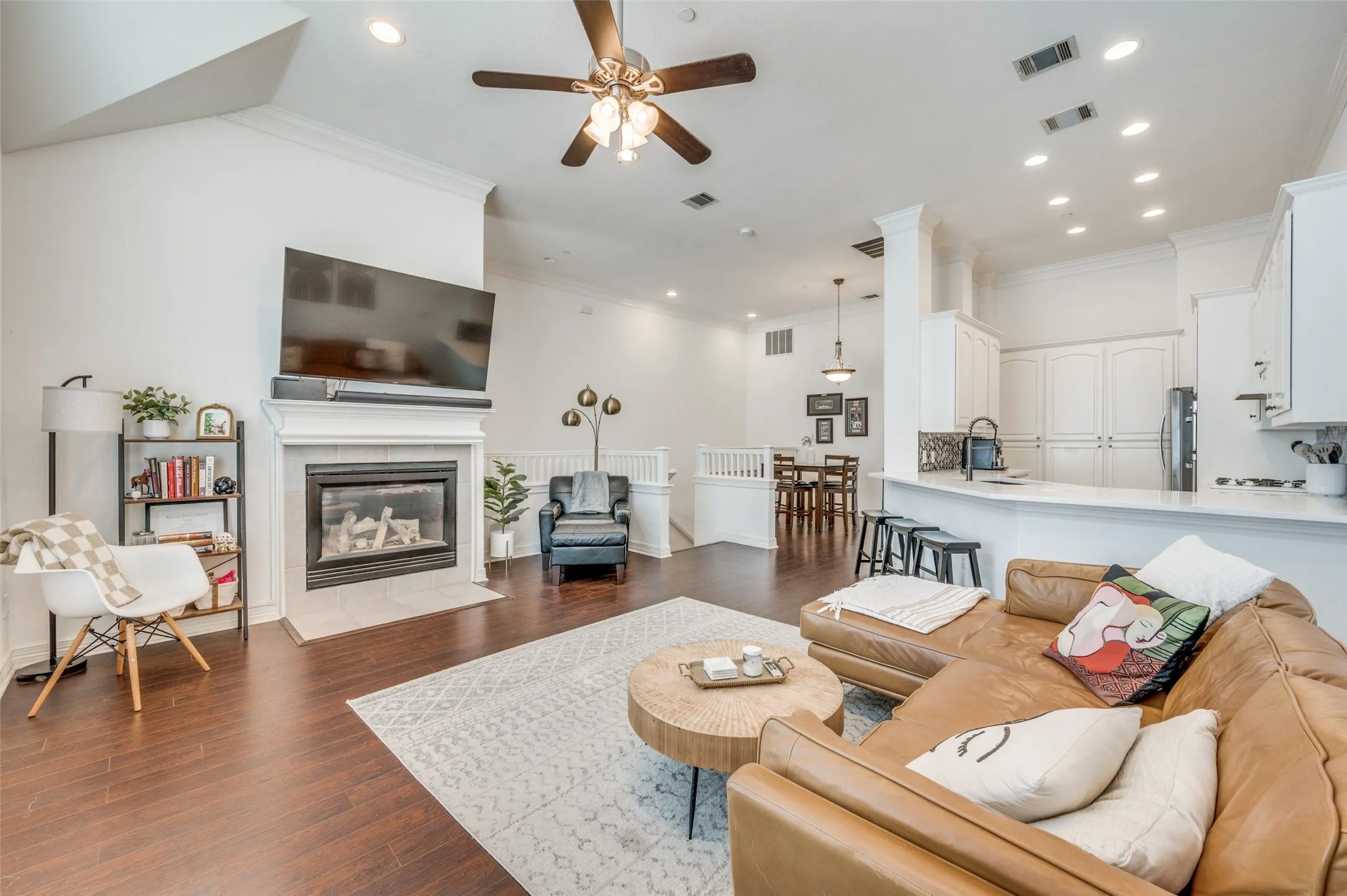 Vaulted ceilings, wood-finish flooring, and a fireplace with a mantel