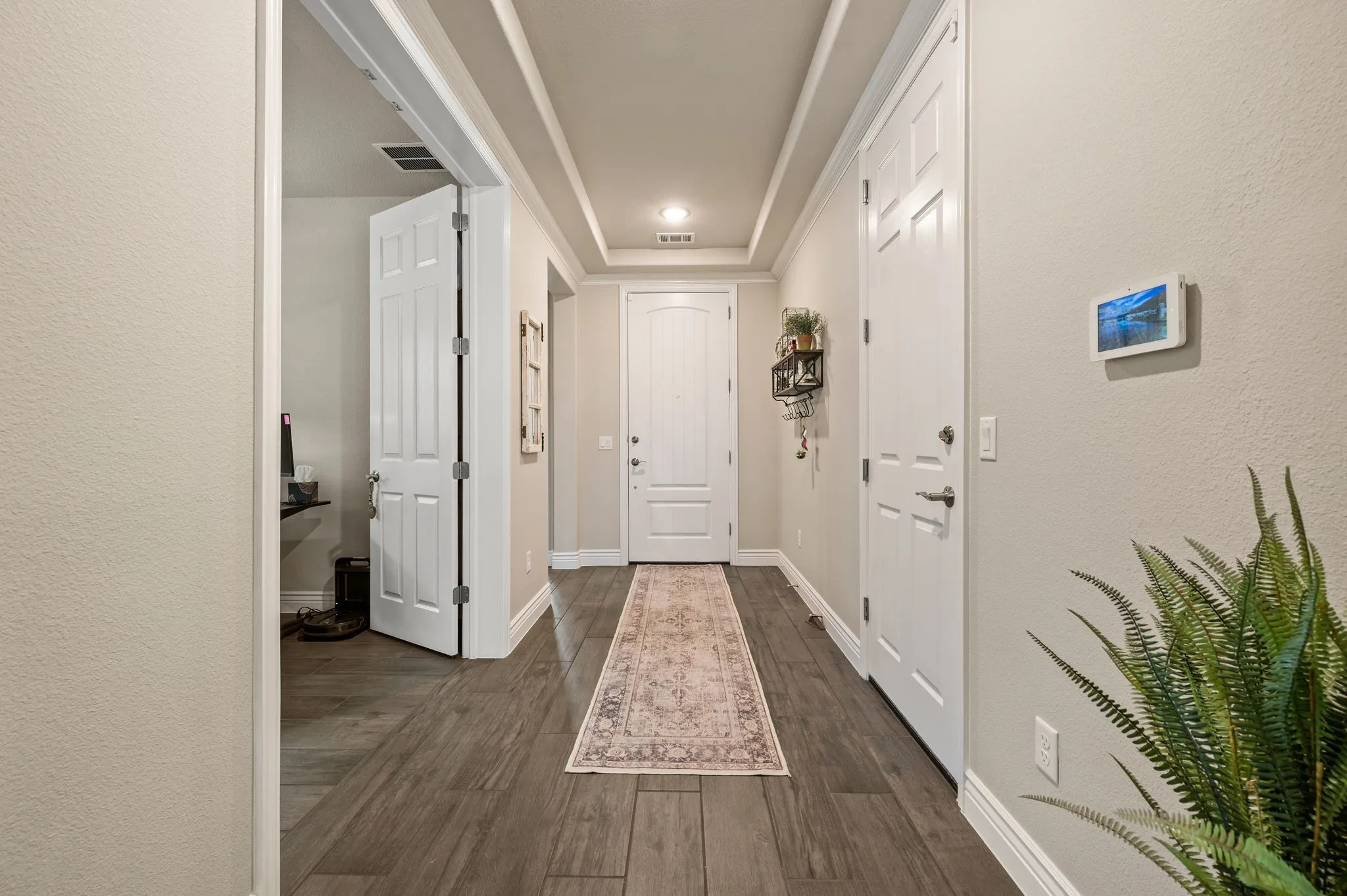 Entrance with tray ceiling and crown molding