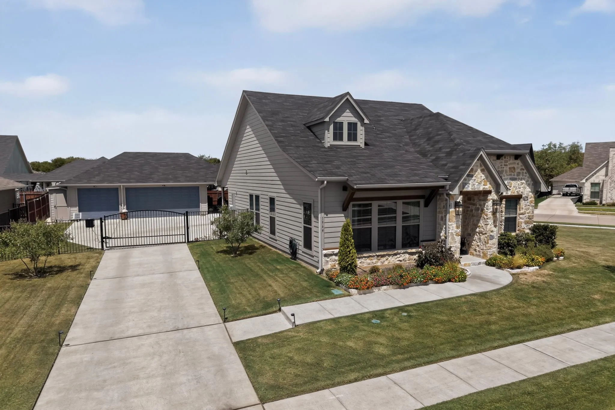 Electric gate across driveway leads to three car garage 30 x 25, big enough to fit a full size truck with plenty of walk around space