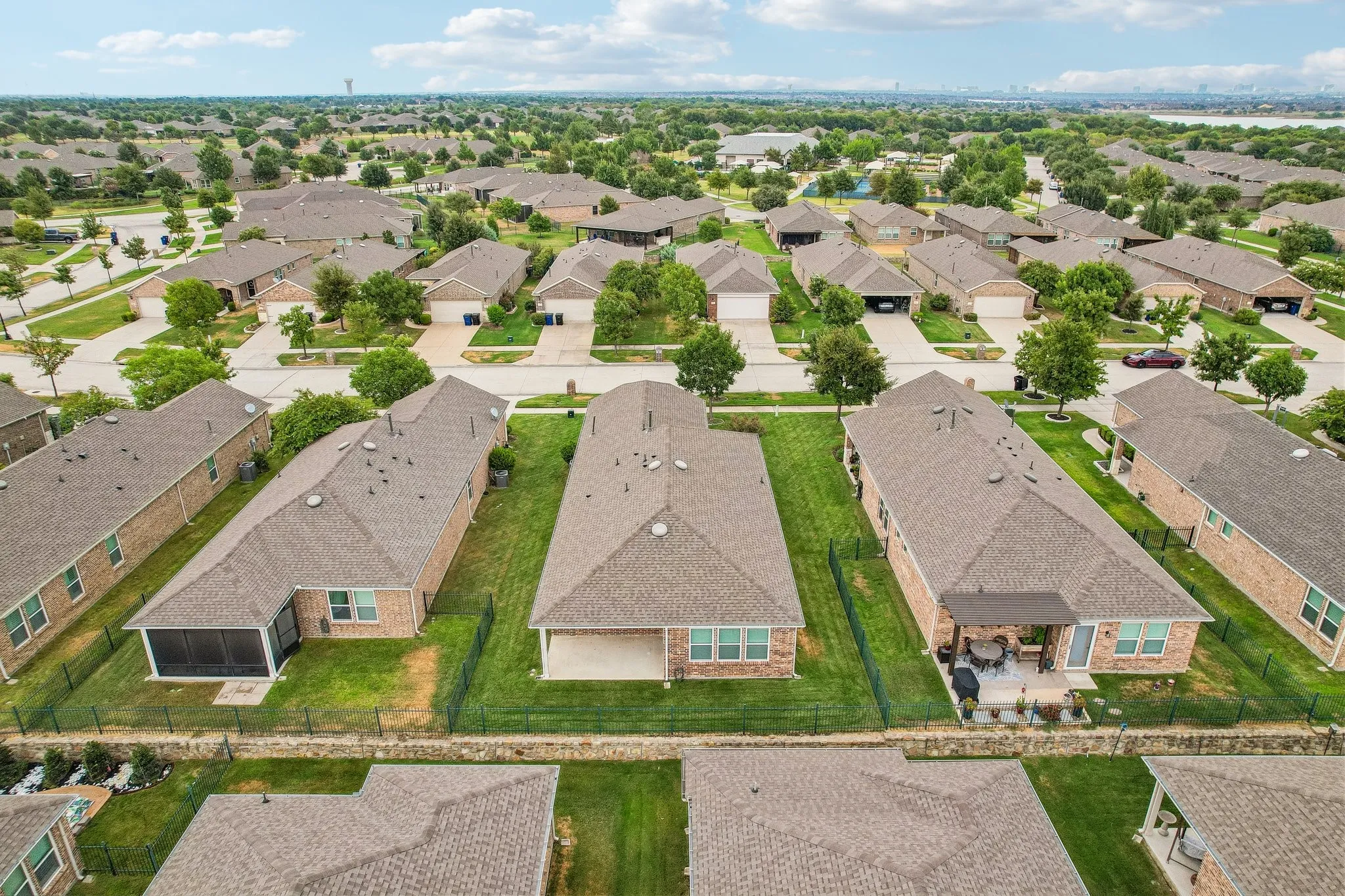 Residential architecture featuring brick exteriors, gabled roofs, and enclosed patios