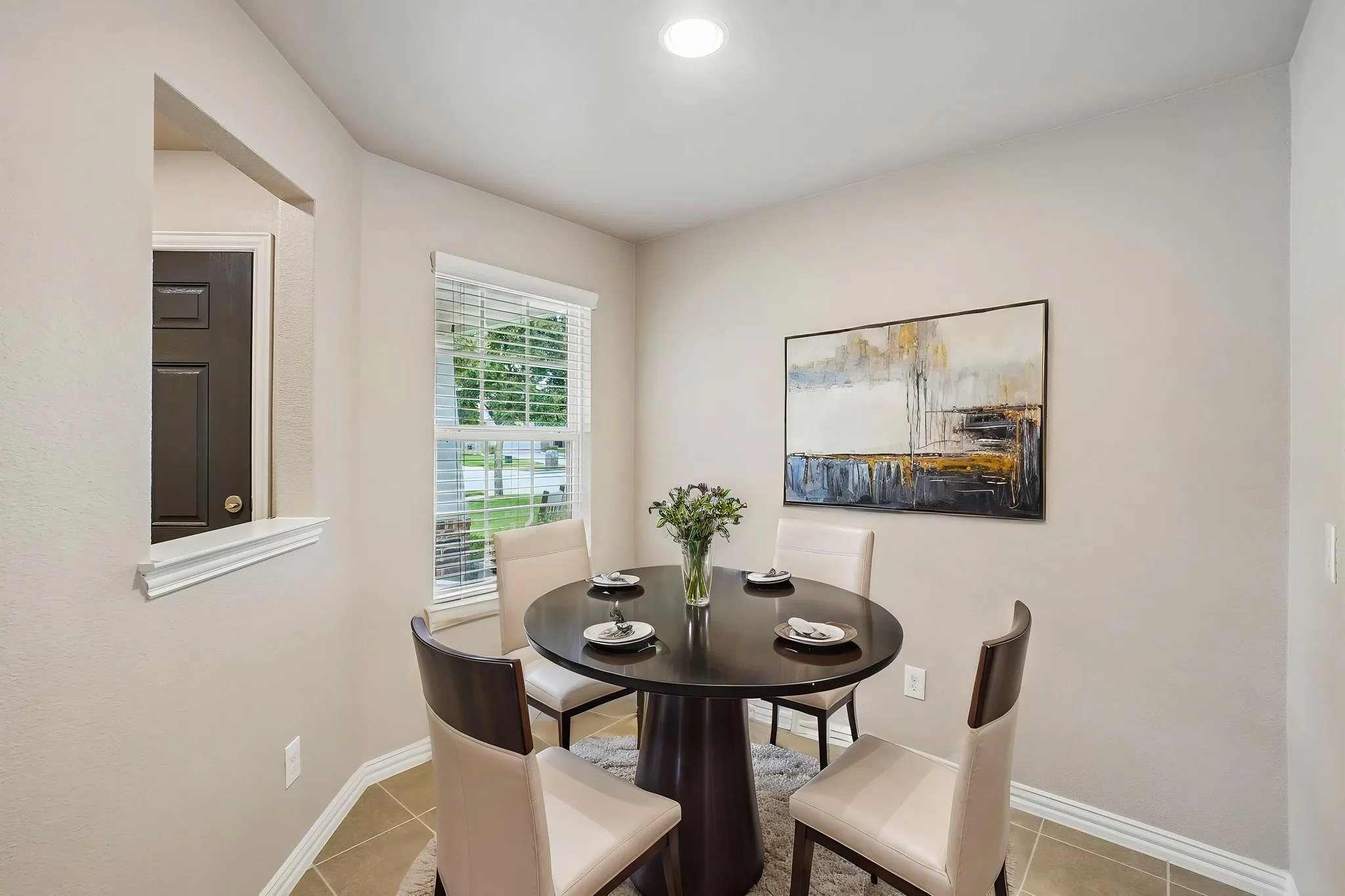 Recessed lighting, window with blinds, tile flooring, and a pass-through opening