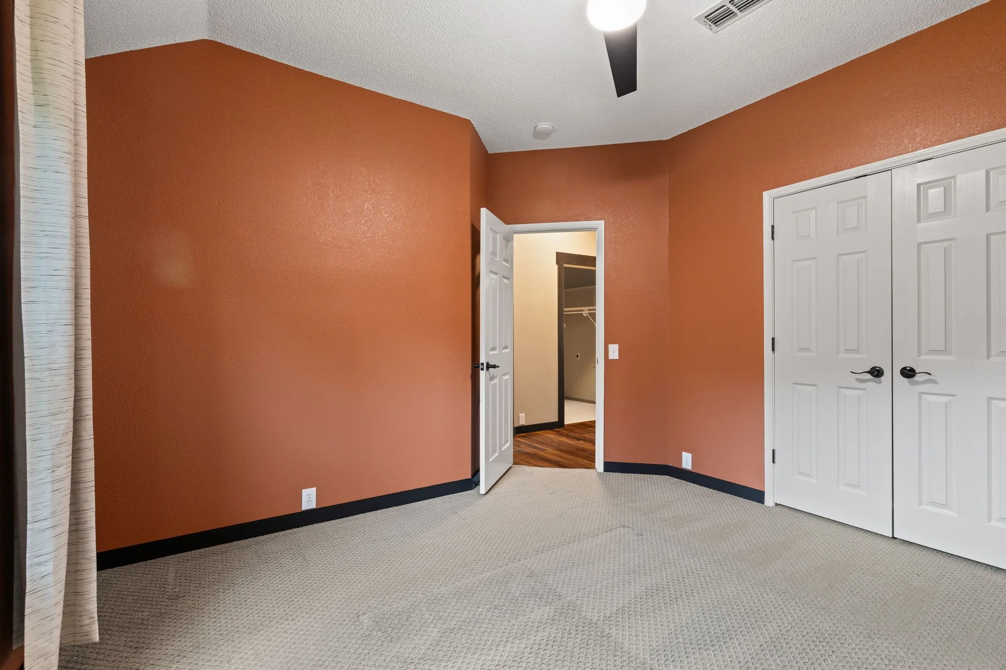 Recessed lighting, ceiling fan, white paneled doors, and light-toned carpet flooring