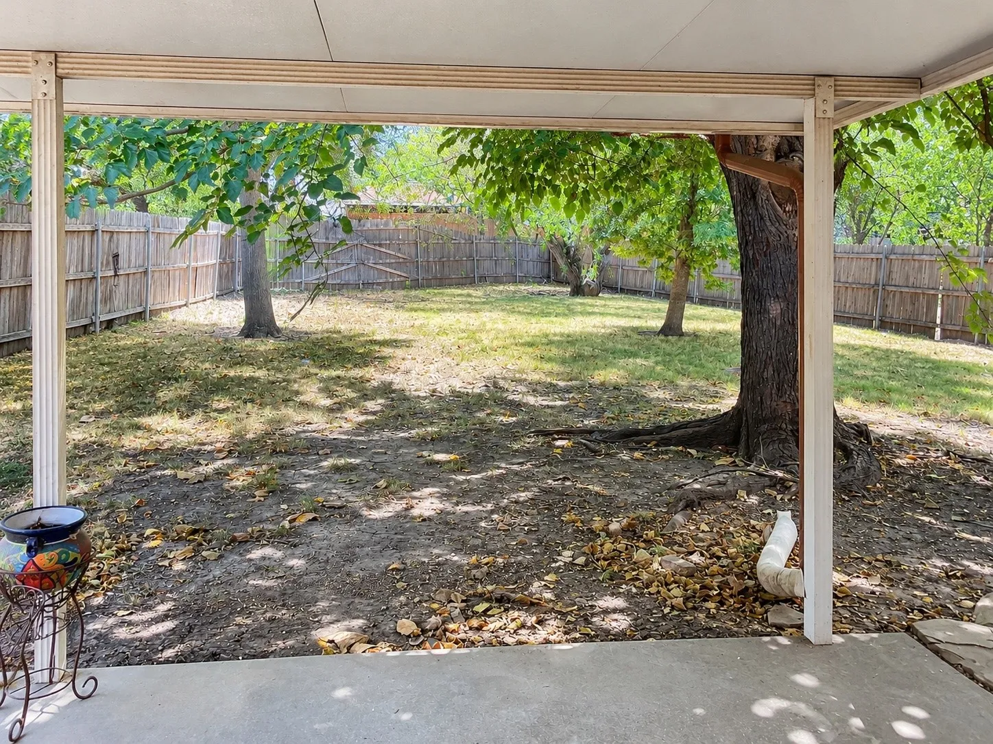 Covered patio featuring a concrete surface and structural support beams