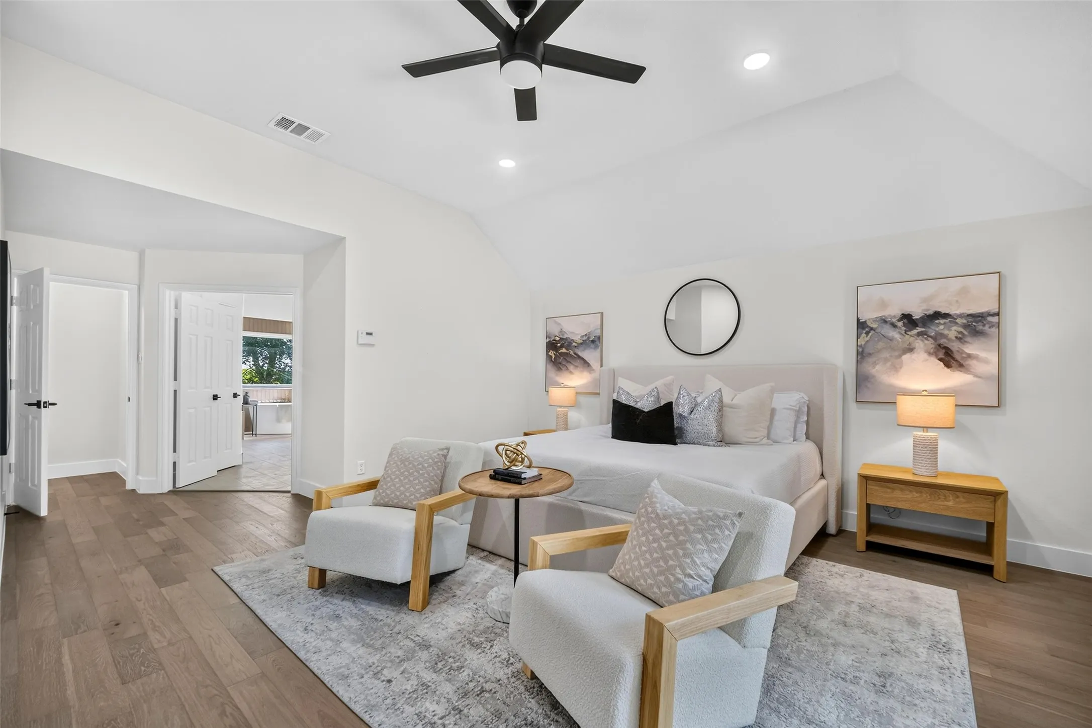 Vaulted ceiling with recessed lighting, wood-finish flooring, white paneled doors, and a ceiling fan with integrated lighting