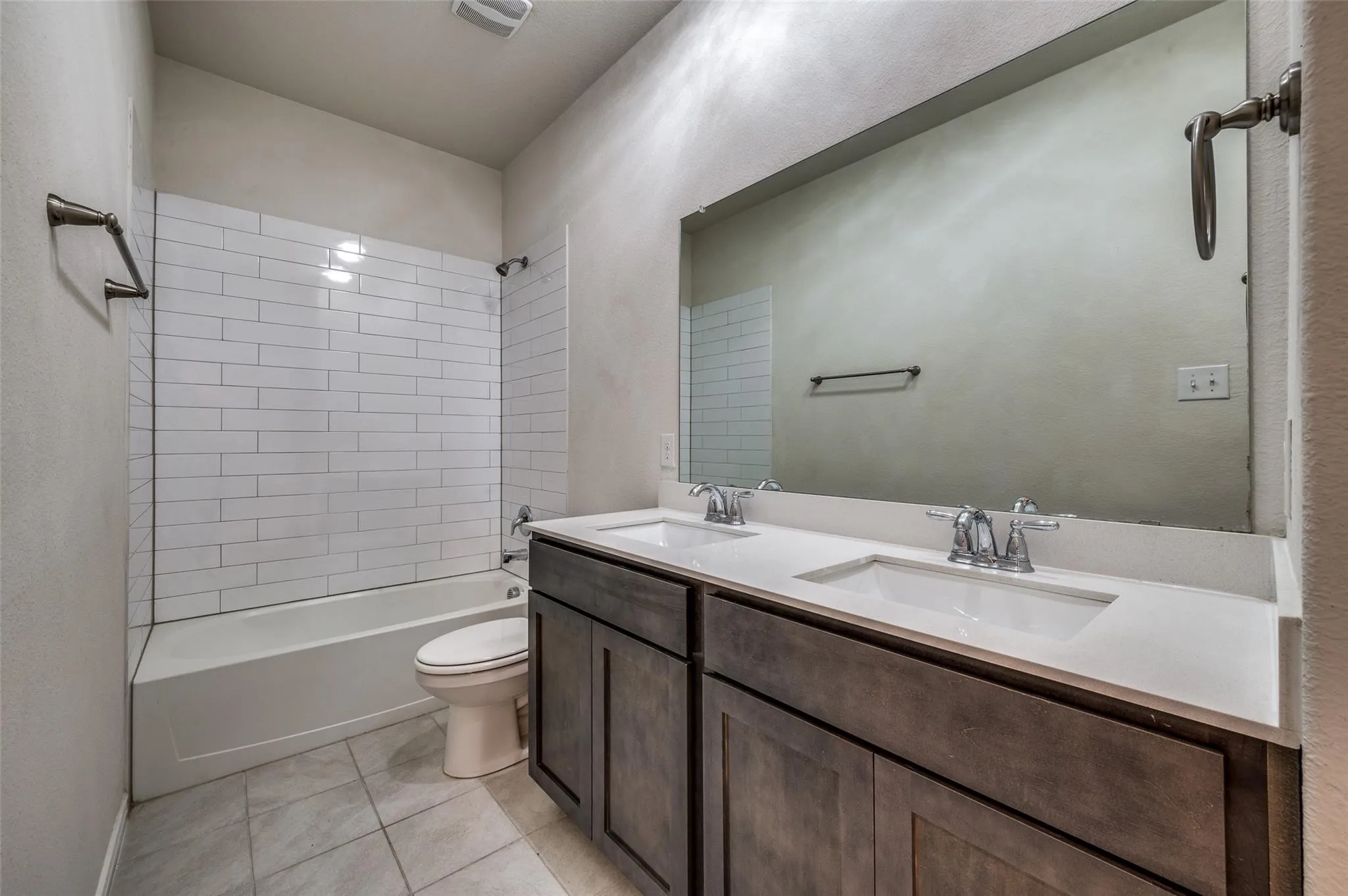 Dual vanity with integrated sinks, white countertop, and chrome faucets