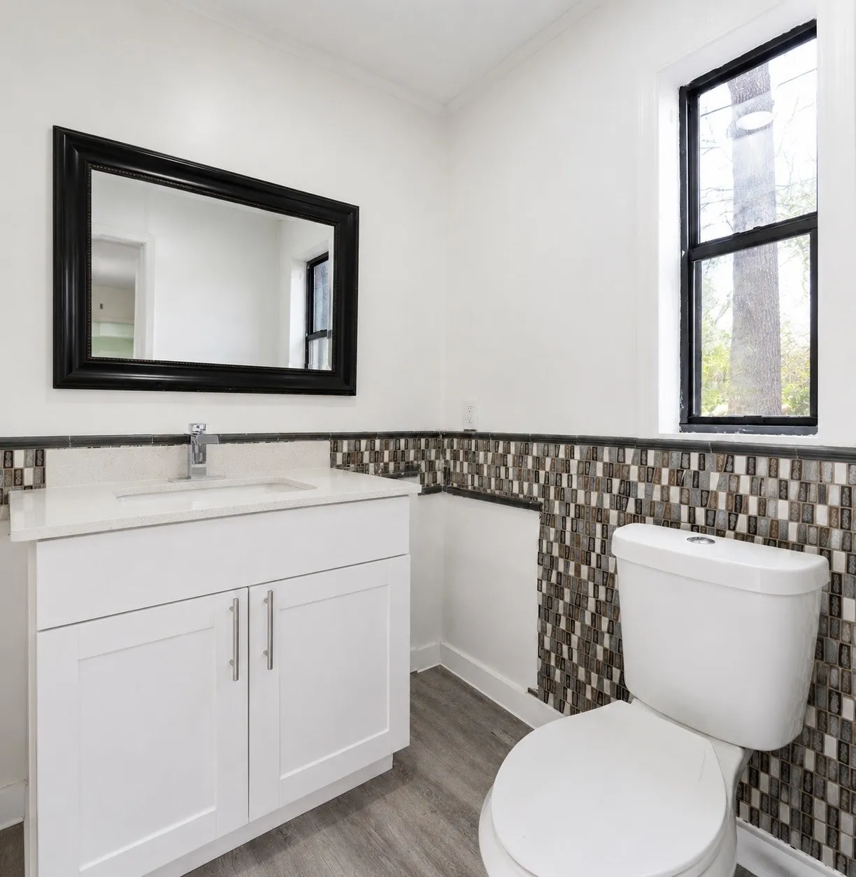 White vanity with an integrated sink, polished chrome faucet, and quartz countertop