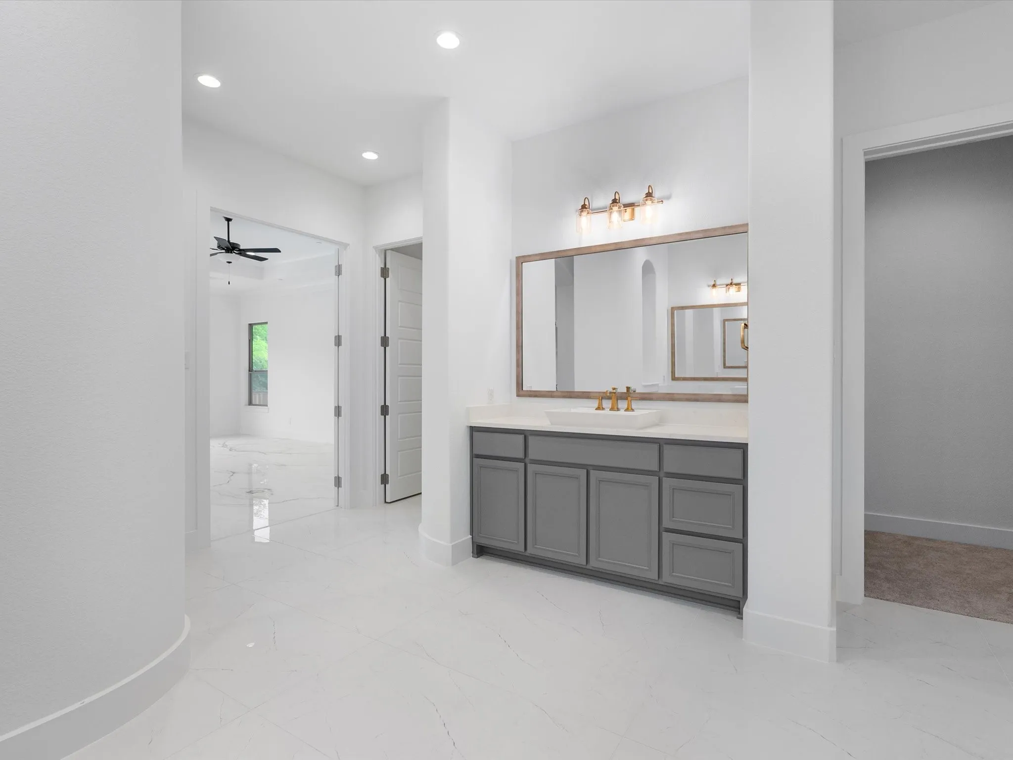 Built-in vanity with gray cabinetry, a rectangular vessel sink, and a light-toned countertop