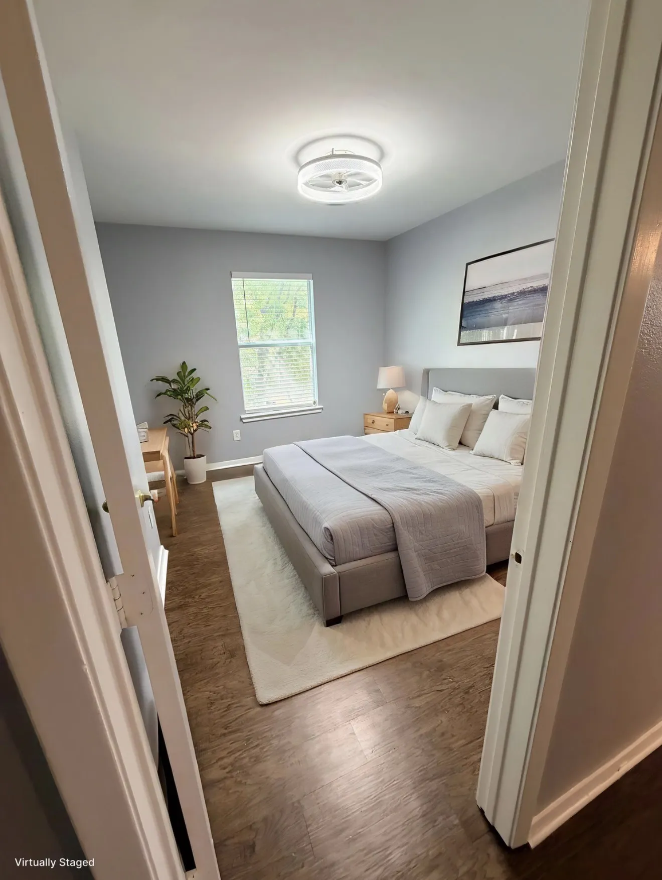 Wood-finish flooring throughout, ceiling-mounted light fixture, and window with blinds
