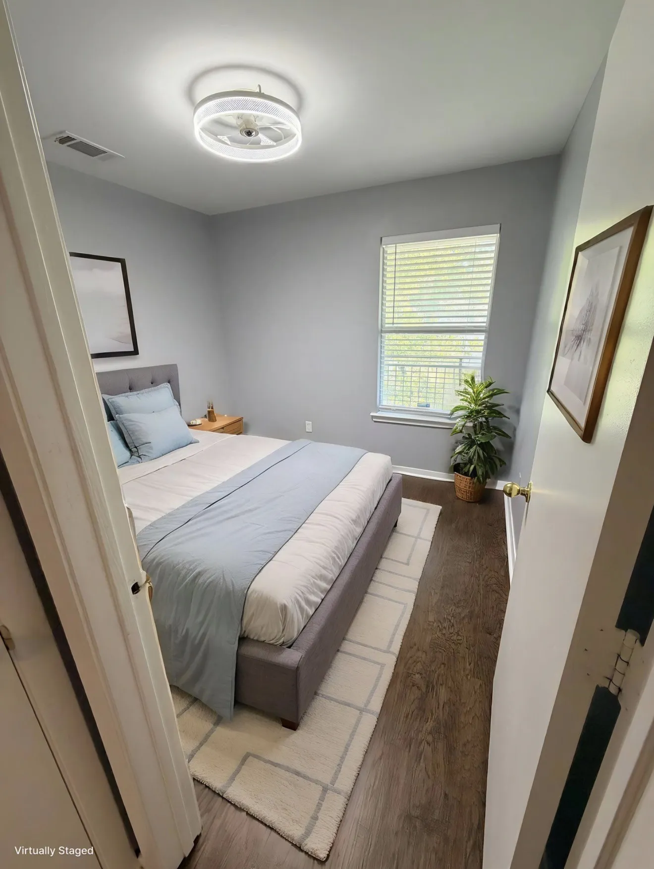 Recessed window, wood-finish flooring, ceiling fan with integrated lighting, light gray wall paint