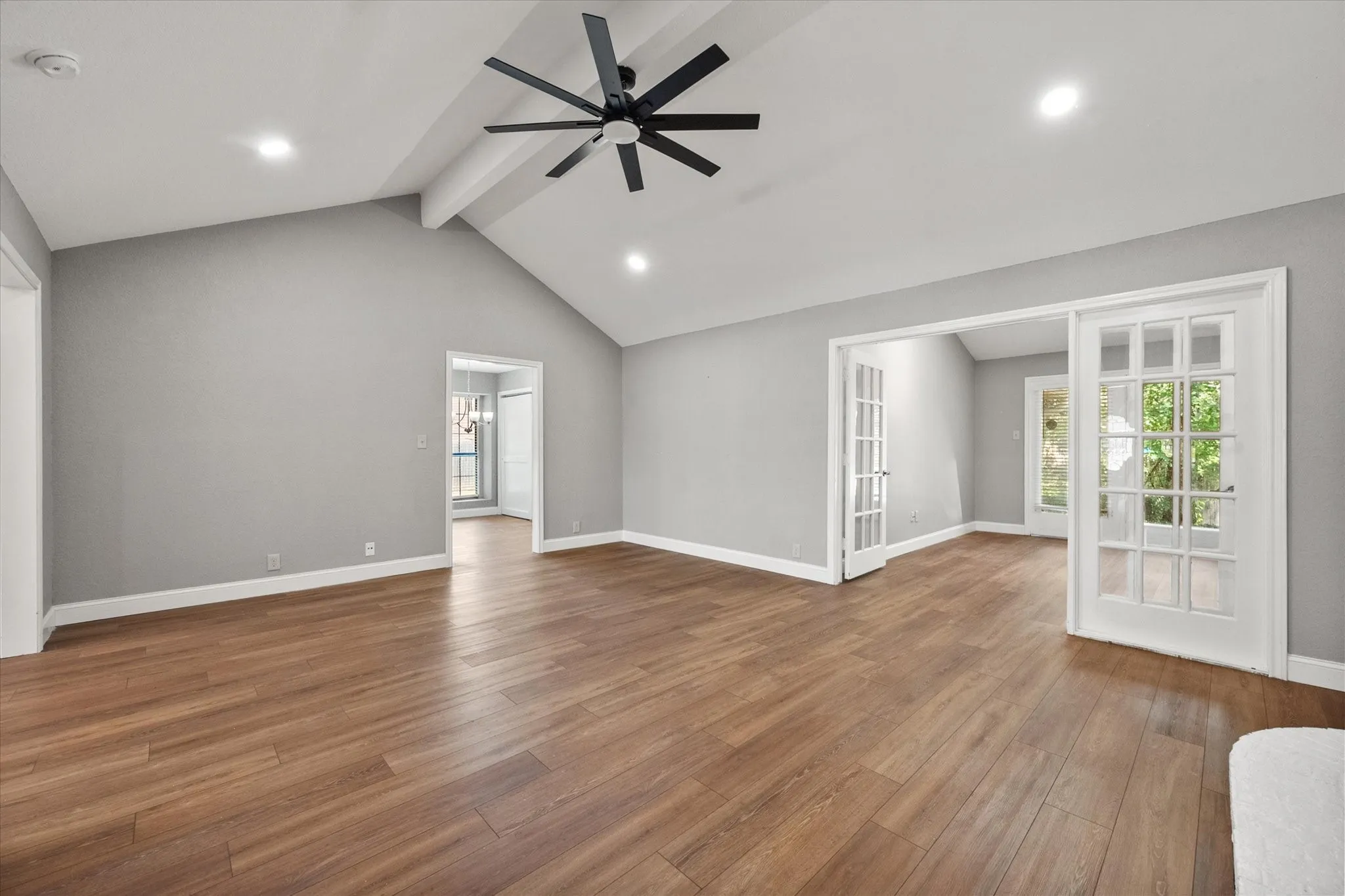 Living room with french doors that lead to sun room and door to the kitchen/eat-in area