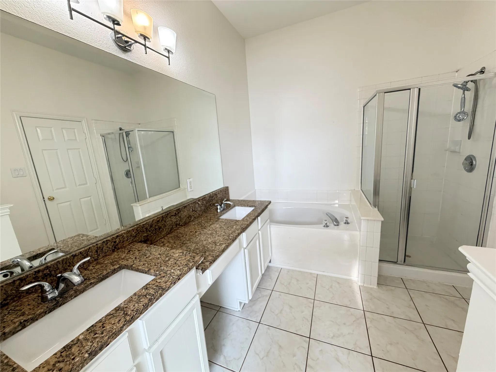 Dual vanity featuring undermount sinks and stone-finish countertops