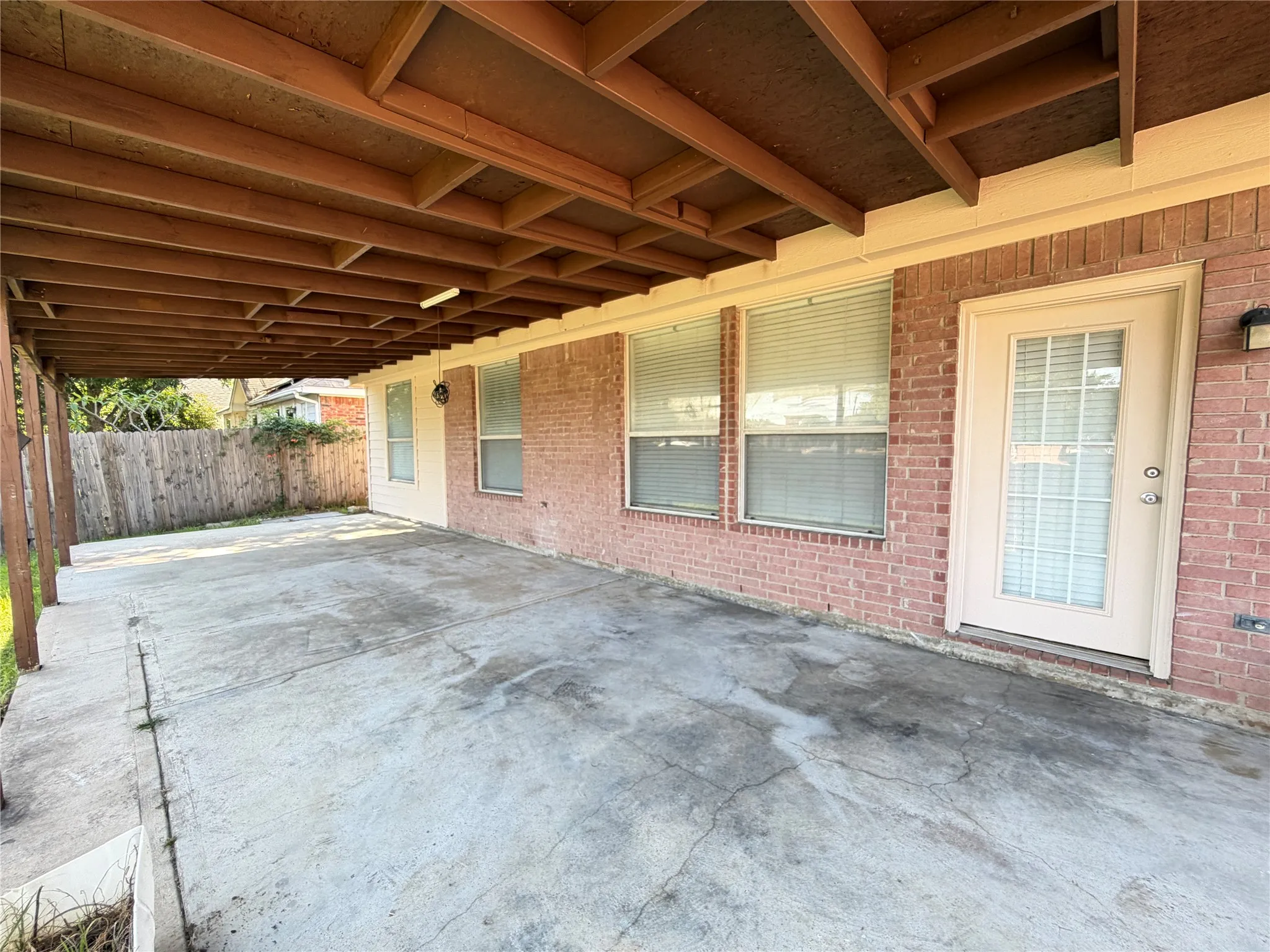 Spacious covered patio with a concrete surface