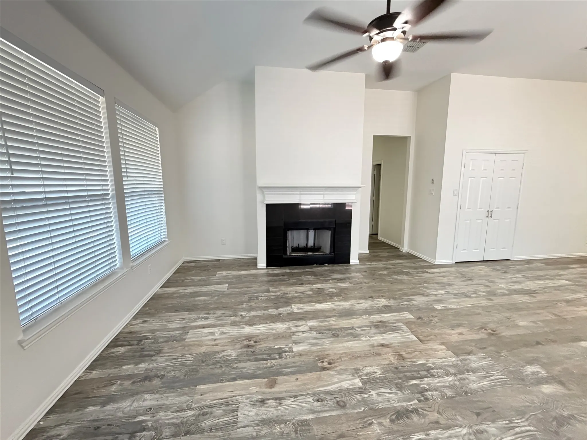 Spacious interior with high ceilings and wood-finish flooring