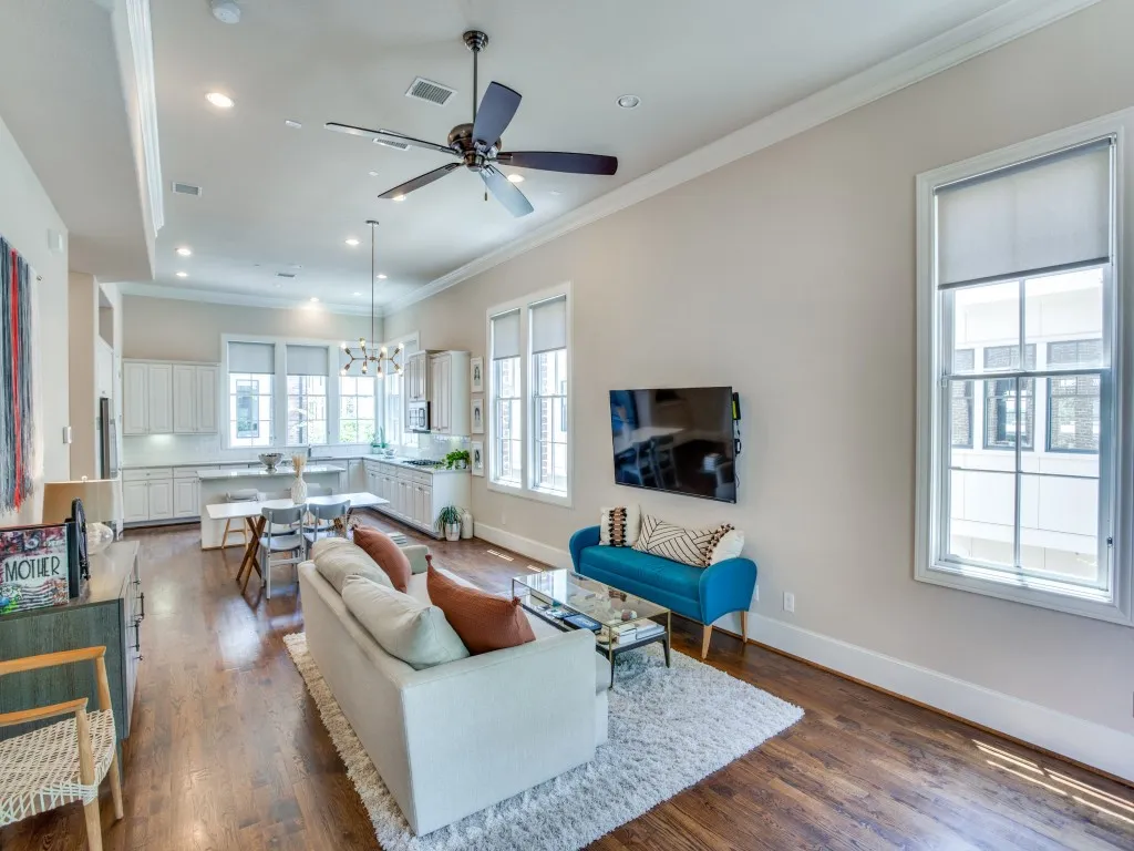 Open-concept living space featuring wood-finish flooring, recessed lighting, and a ceiling fan