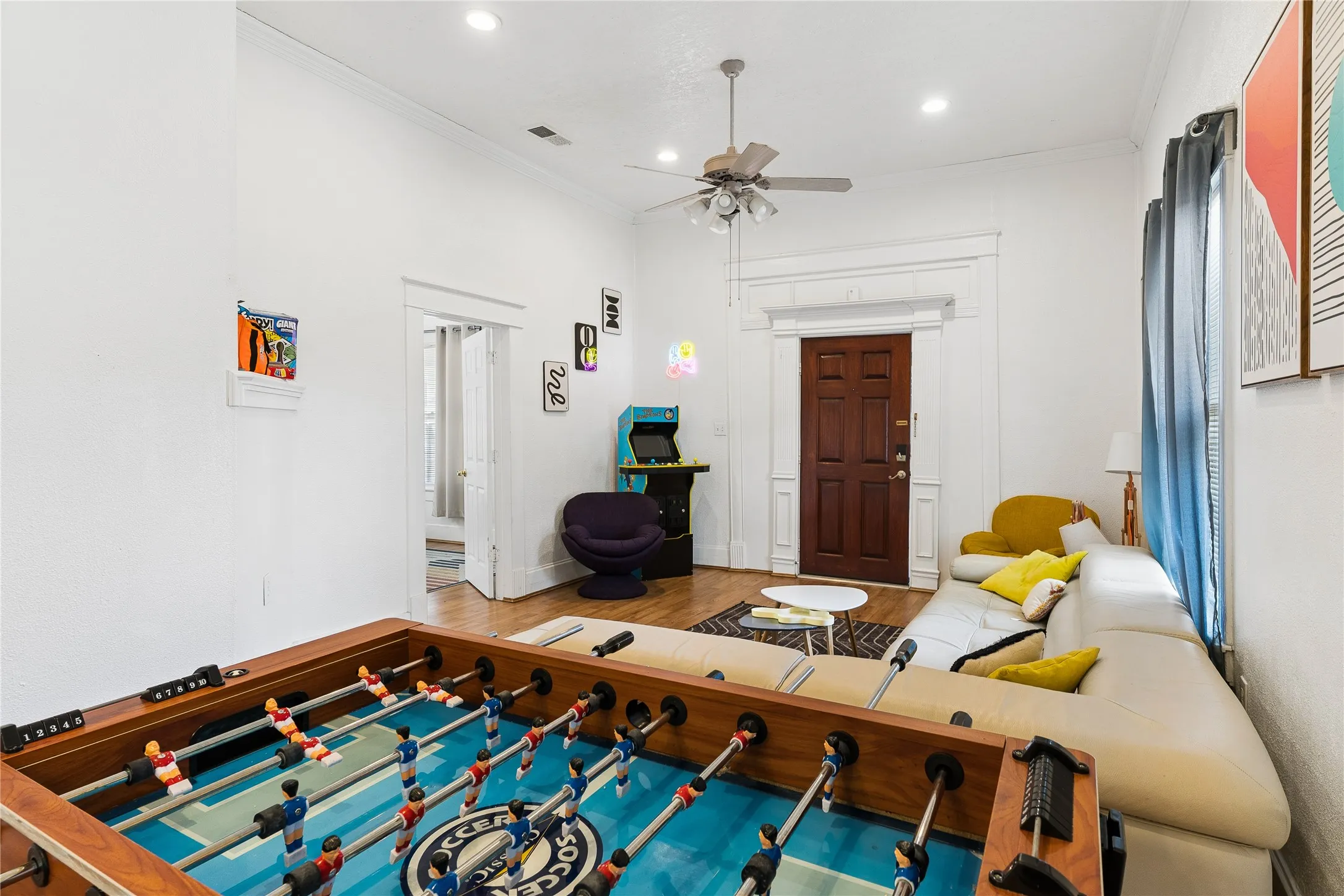 Hardwood flooring throughout, recessed lighting, and crown molding