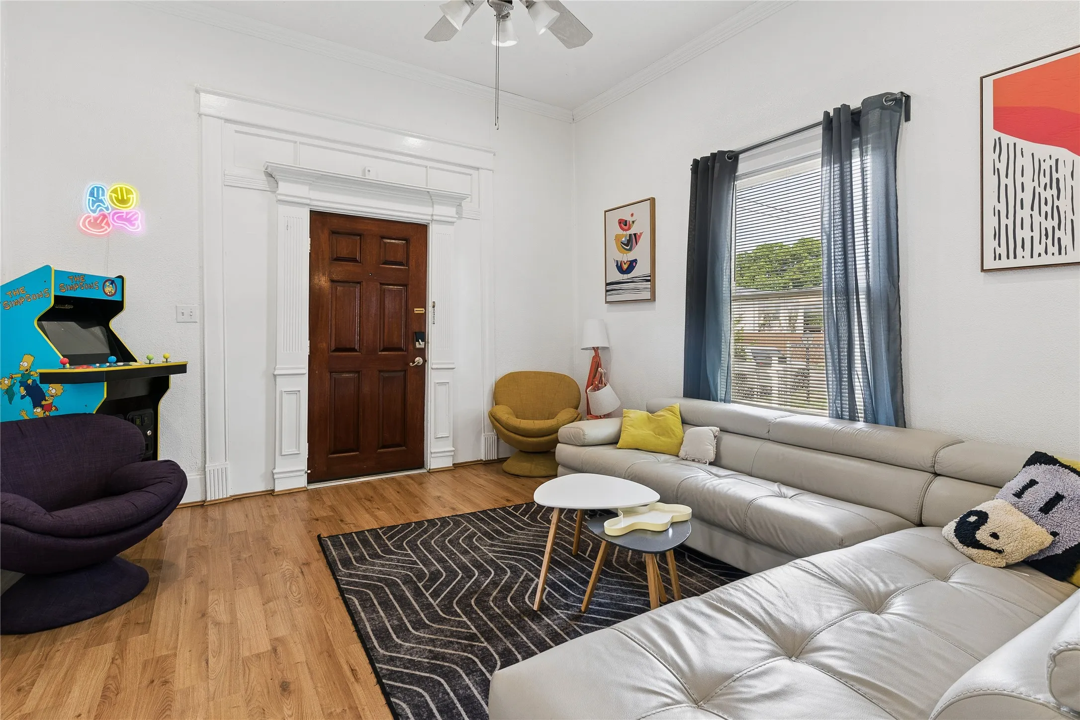 Warm wood-finish flooring complements the white walls