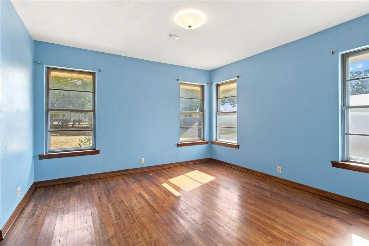 Lots of natural light and fresh blue painted wall in the primary bedroom
