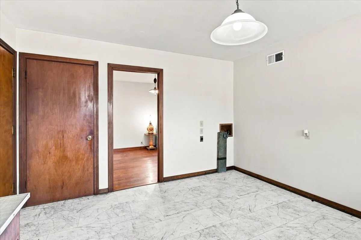 Eat-in kitchen with space for a washer and dryer