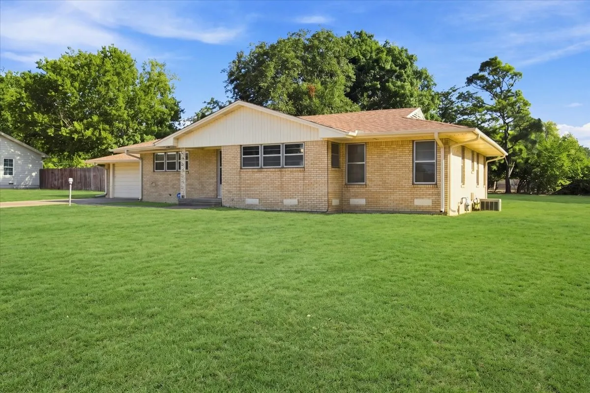 Front exterior - artificially greened yard due to season