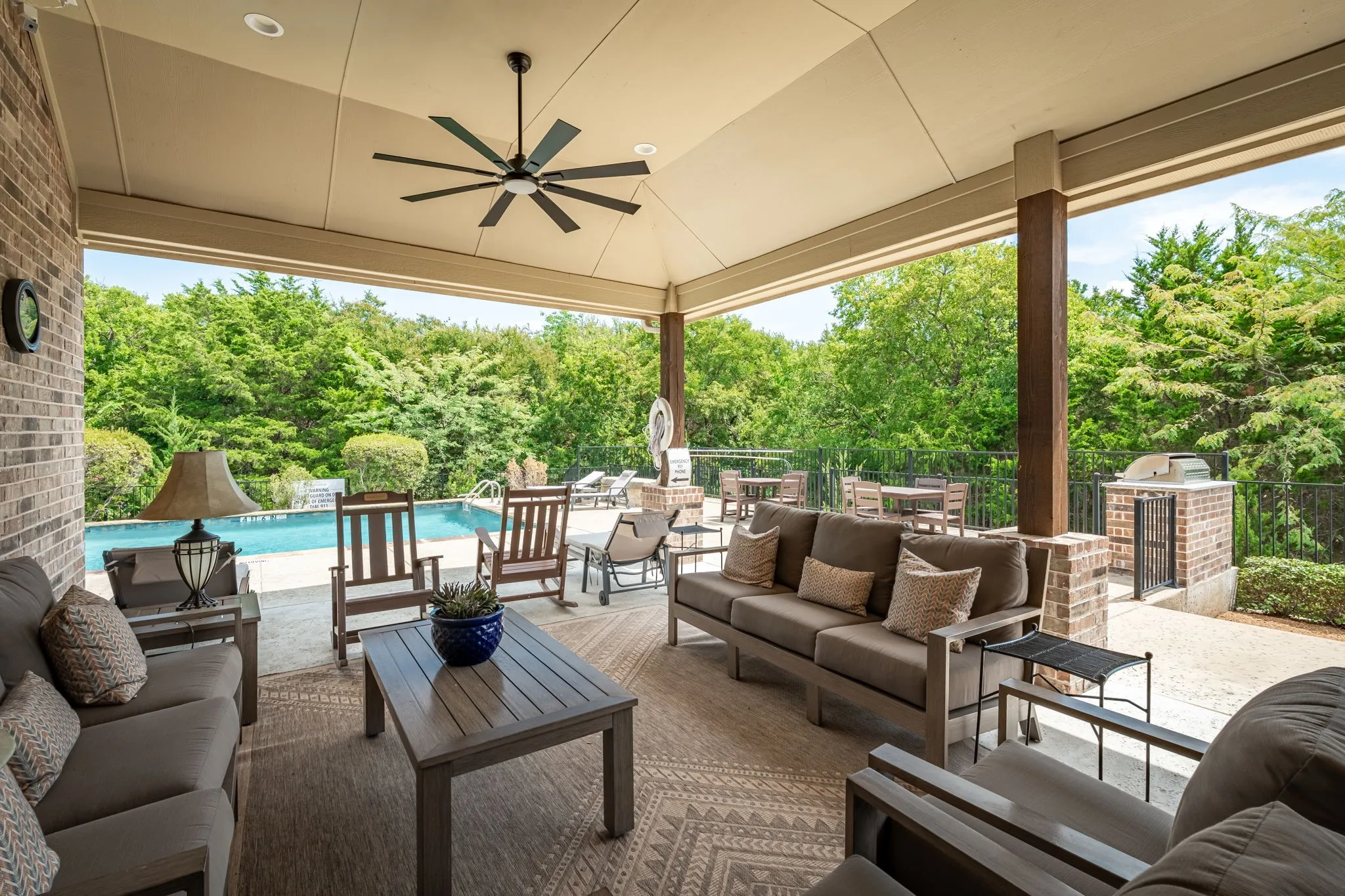 Community Center Covered patio with exposed brick wall, ceiling fan, recessed lighting, and built-in outdoor grilling station