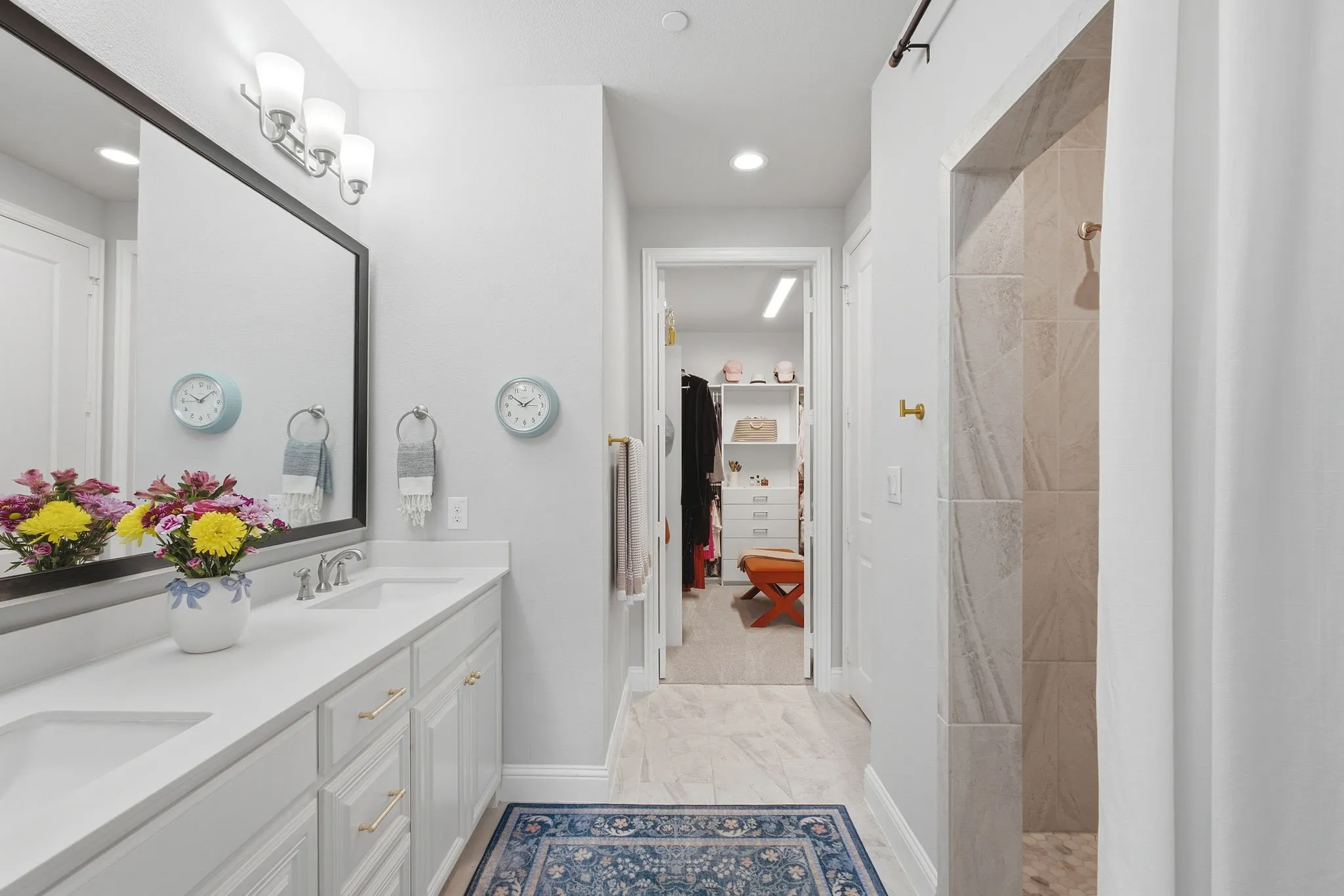 Dual vanity with white cabinetry, quartz countertop, and undermount sinks