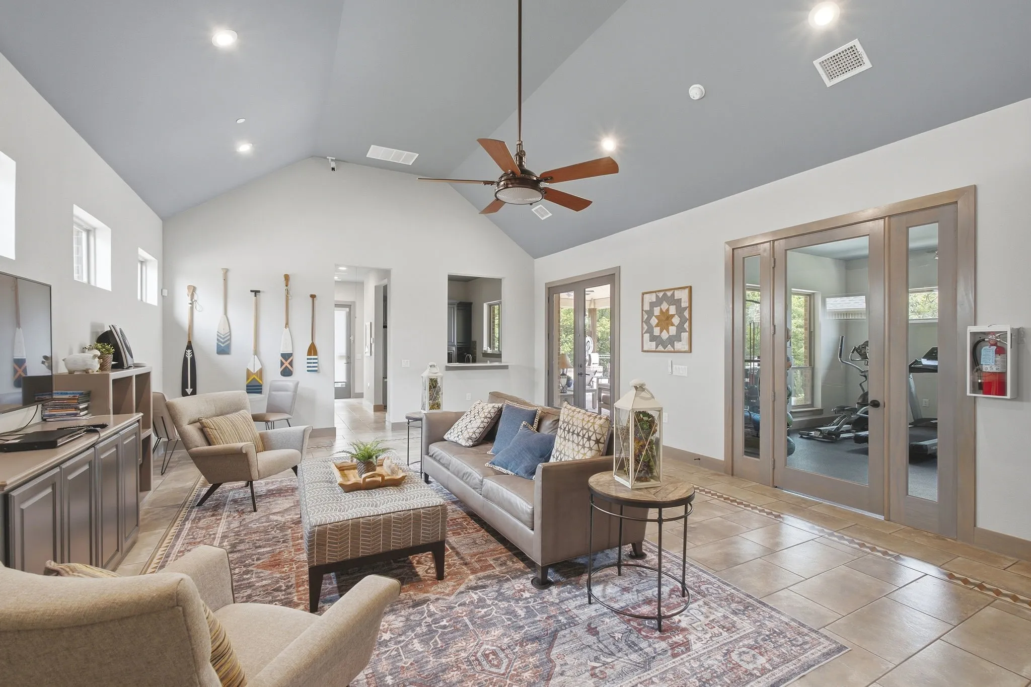 Community Center Entertaining Space with Vaulted ceiling with recessed lighting and a ceiling fan, tile flooring, and double glass-paneled doors
