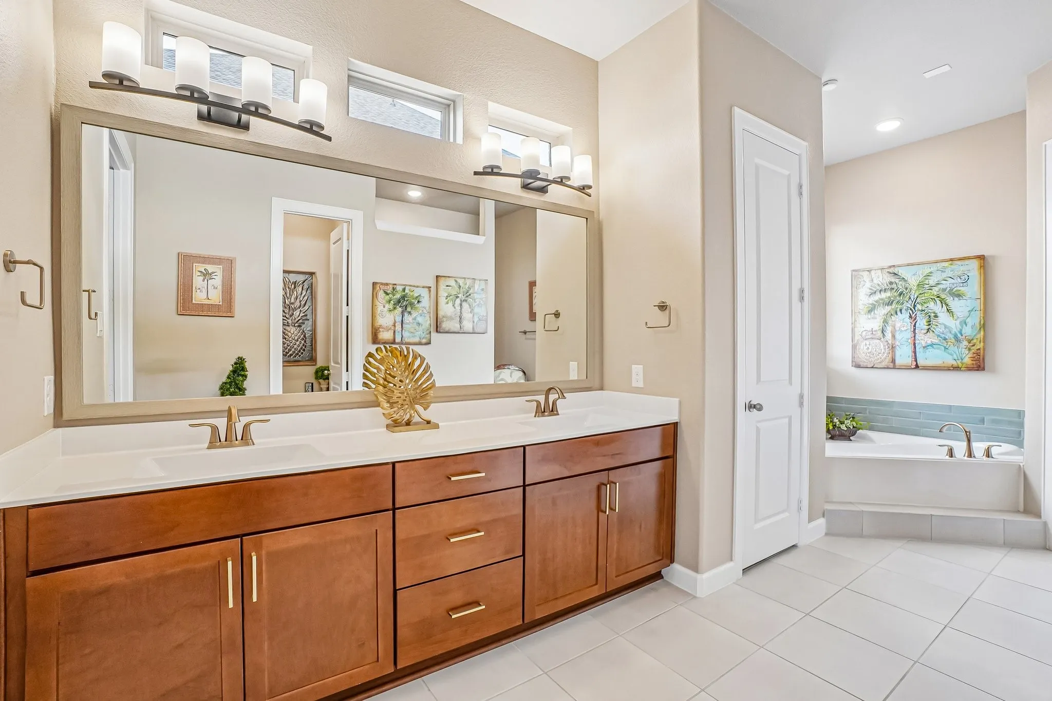 Dual sinks & sitting area in primary bathroom
