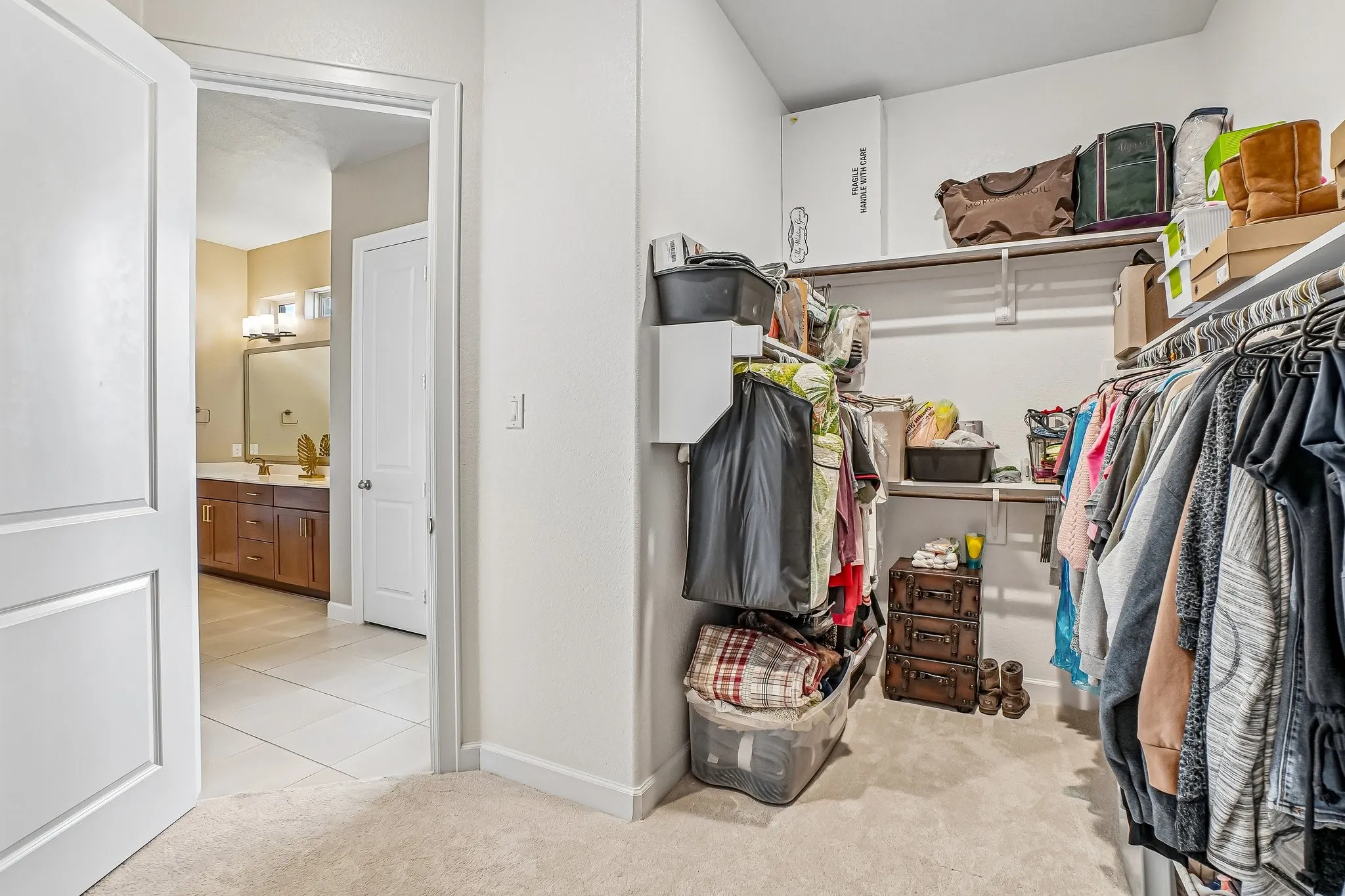 Walk-in closet in primary bathroom also opens to laundry room