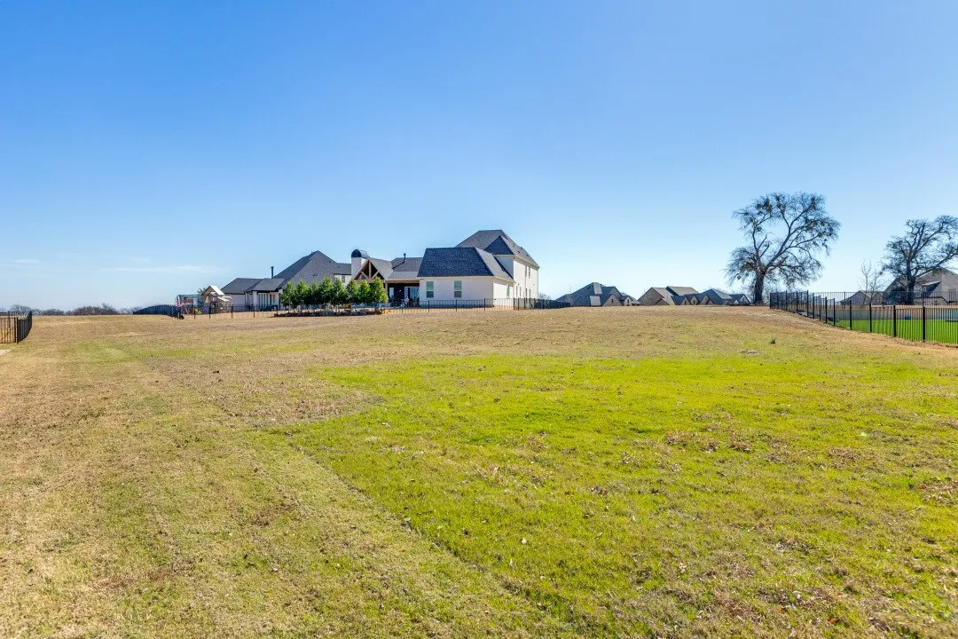 Front view of the expansive grassy lot
