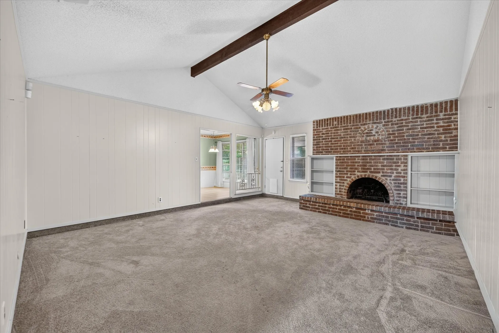 Living Room with Large Brick Fireplace and Built-Ins
