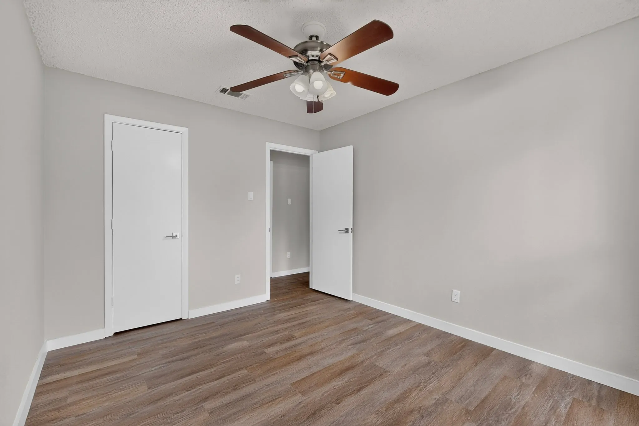 Neutral wall tones with wood-finish flooring