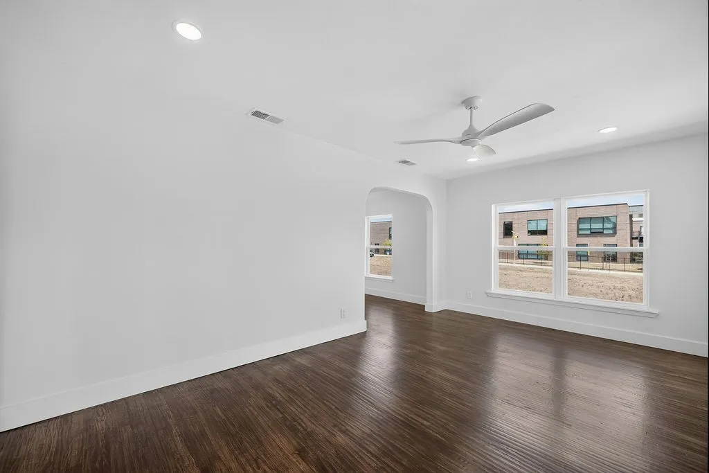Wood-finish flooring throughout, recessed lighting, and a contemporary ceiling fan