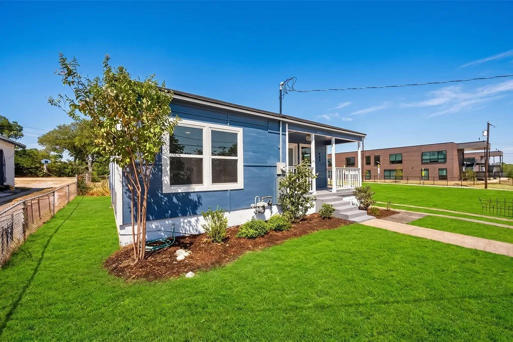 Blue exterior siding with white trim and multi-pane windows