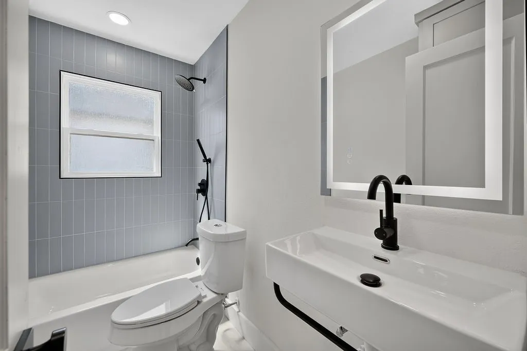 Vertical-stacked tile shower surround with a fixed-pane window