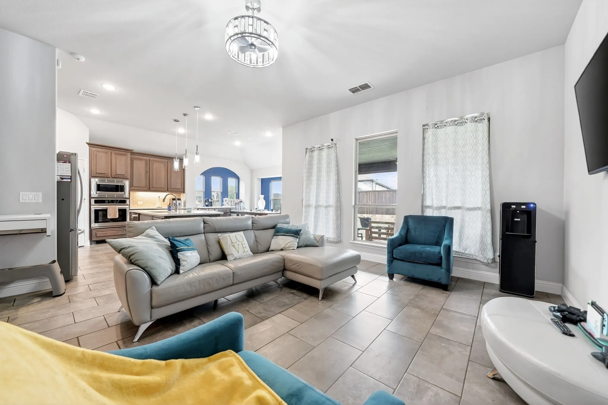 Recessed lighting, tiled flooring, stainless steel appliances, built-in double oven, and pendant lighting