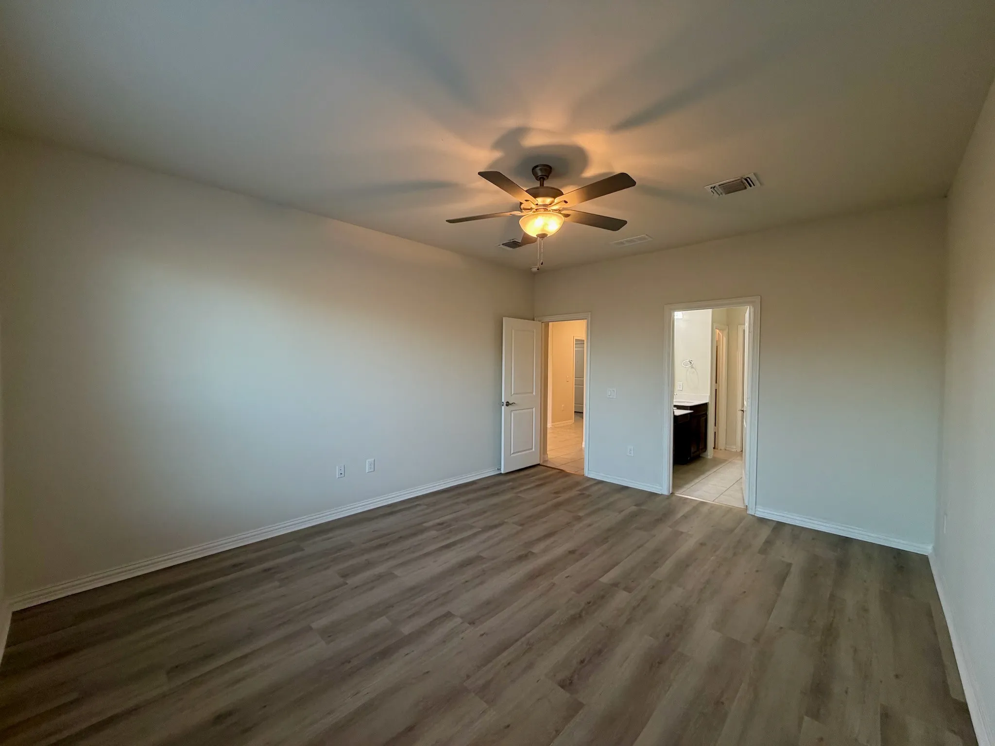 Recessed lighting, wood-finish flooring, ceiling fan with integrated lighting, neutral wall tones, and white trim
