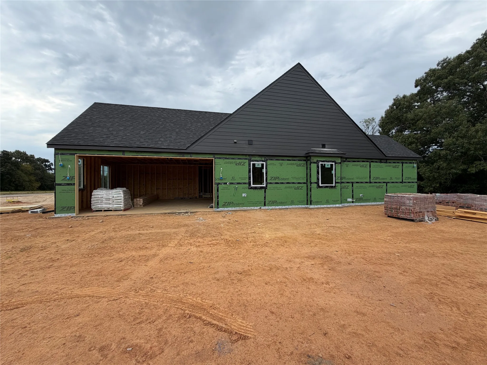 Side of home featuring side garage.
