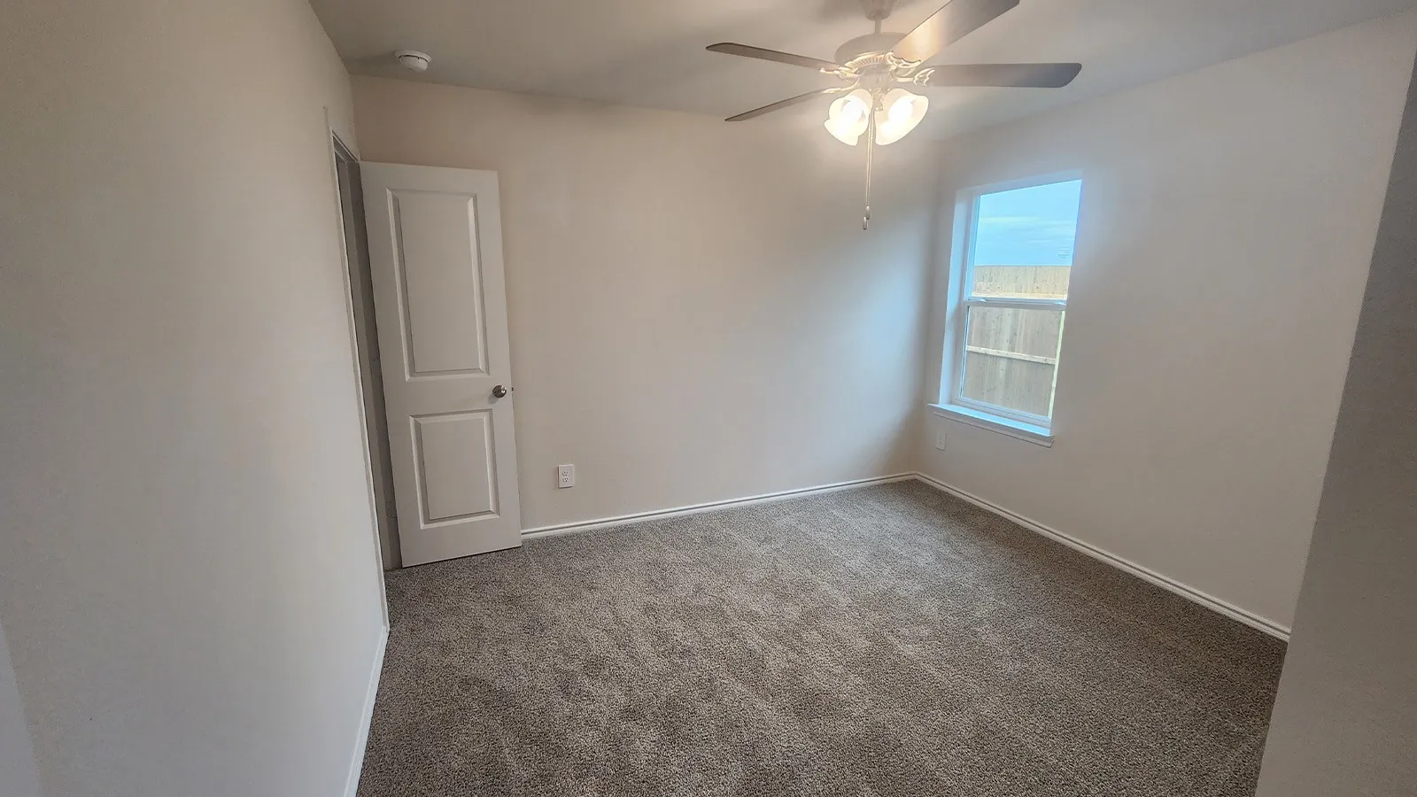 Neutral-toned walls complement plush carpeting