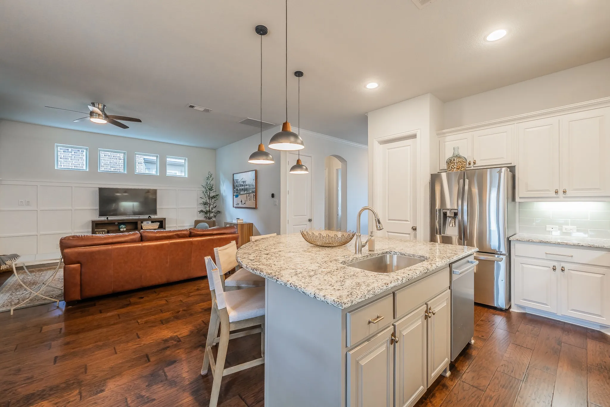 Kitchen island with a built-in sink and granite countertop