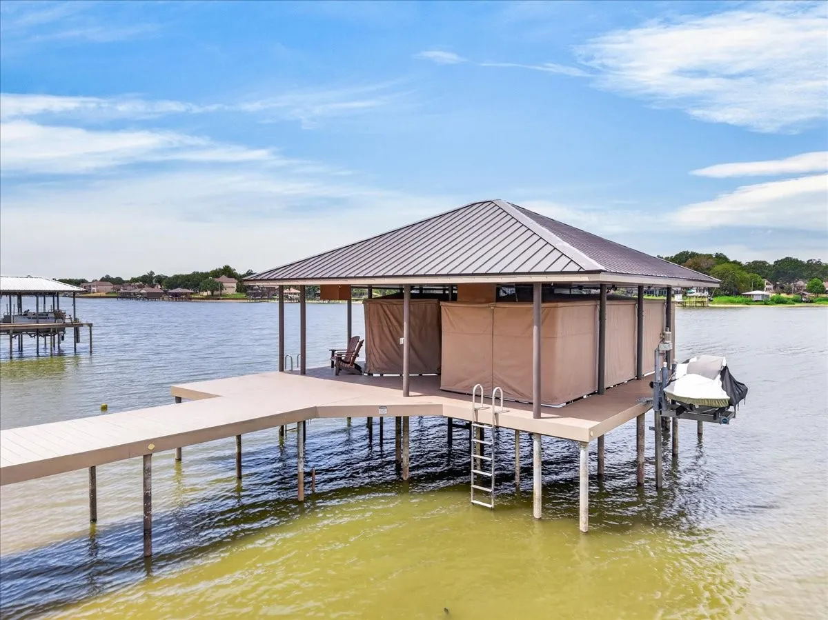 This dock is less than 5 years old, all composite with touchlss boat covers on 27 and 30 ft boat slips. Both have aluminum cradles.