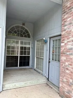 Small deck at rear of home with entrance door into owner's suite
