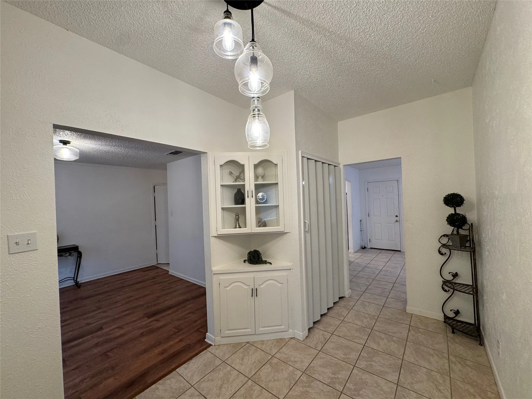 Entry with decorative built-in and ceramic tile flooring