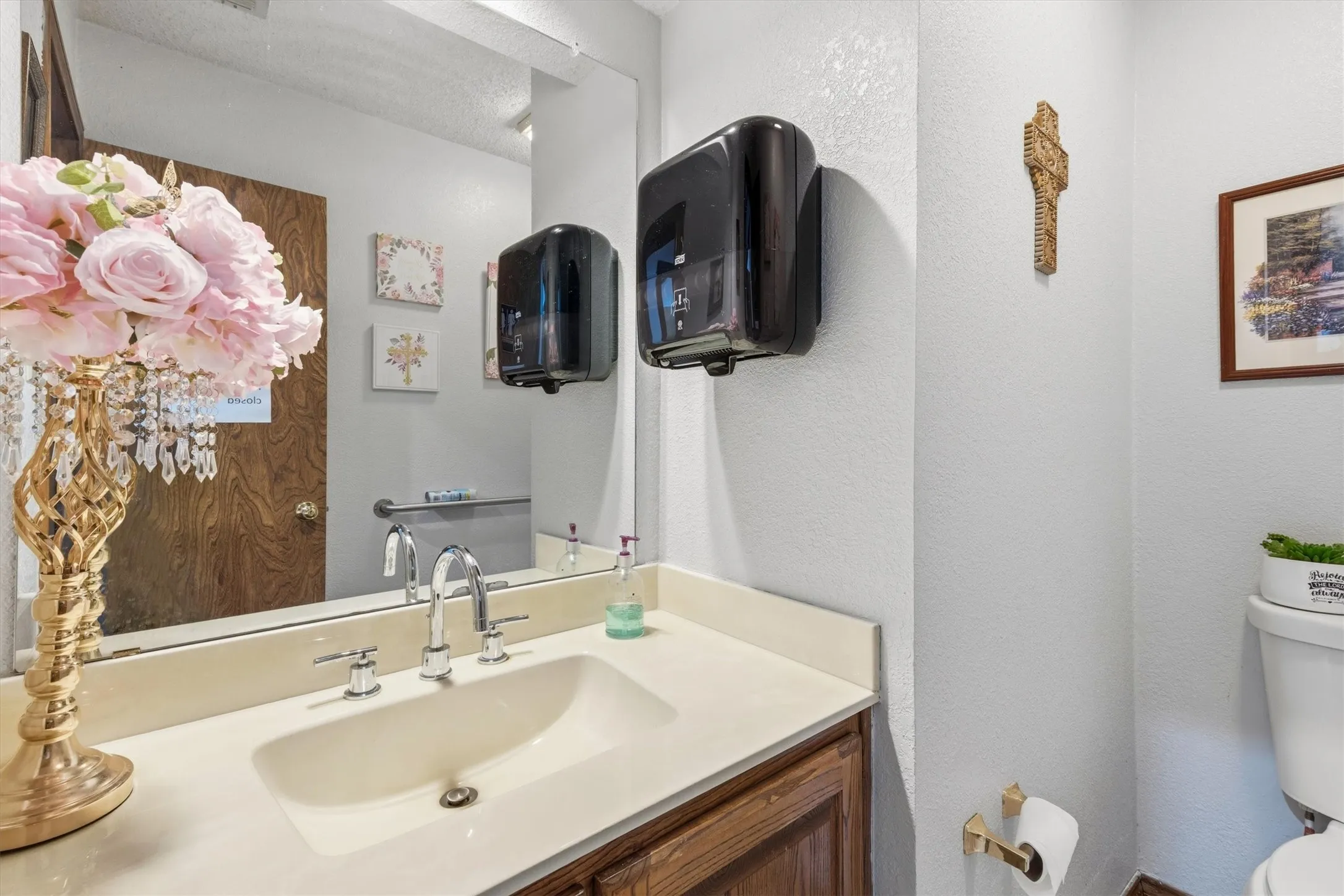 Vanity with an integrated sink, chrome faucet, and wood-finish cabinetry