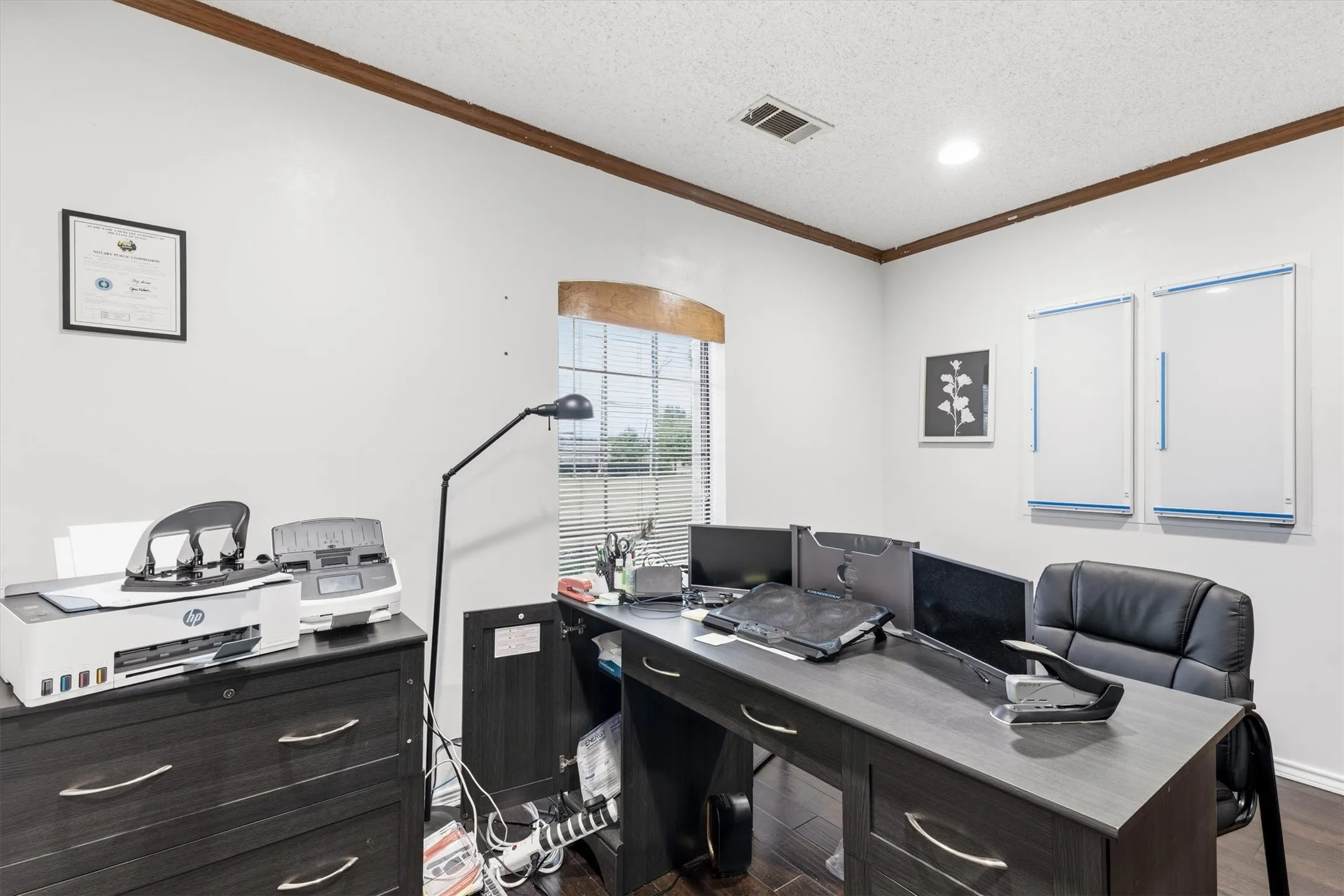 Recessed ceiling lighting, wood-finish flooring, and a window with horizontal blinds