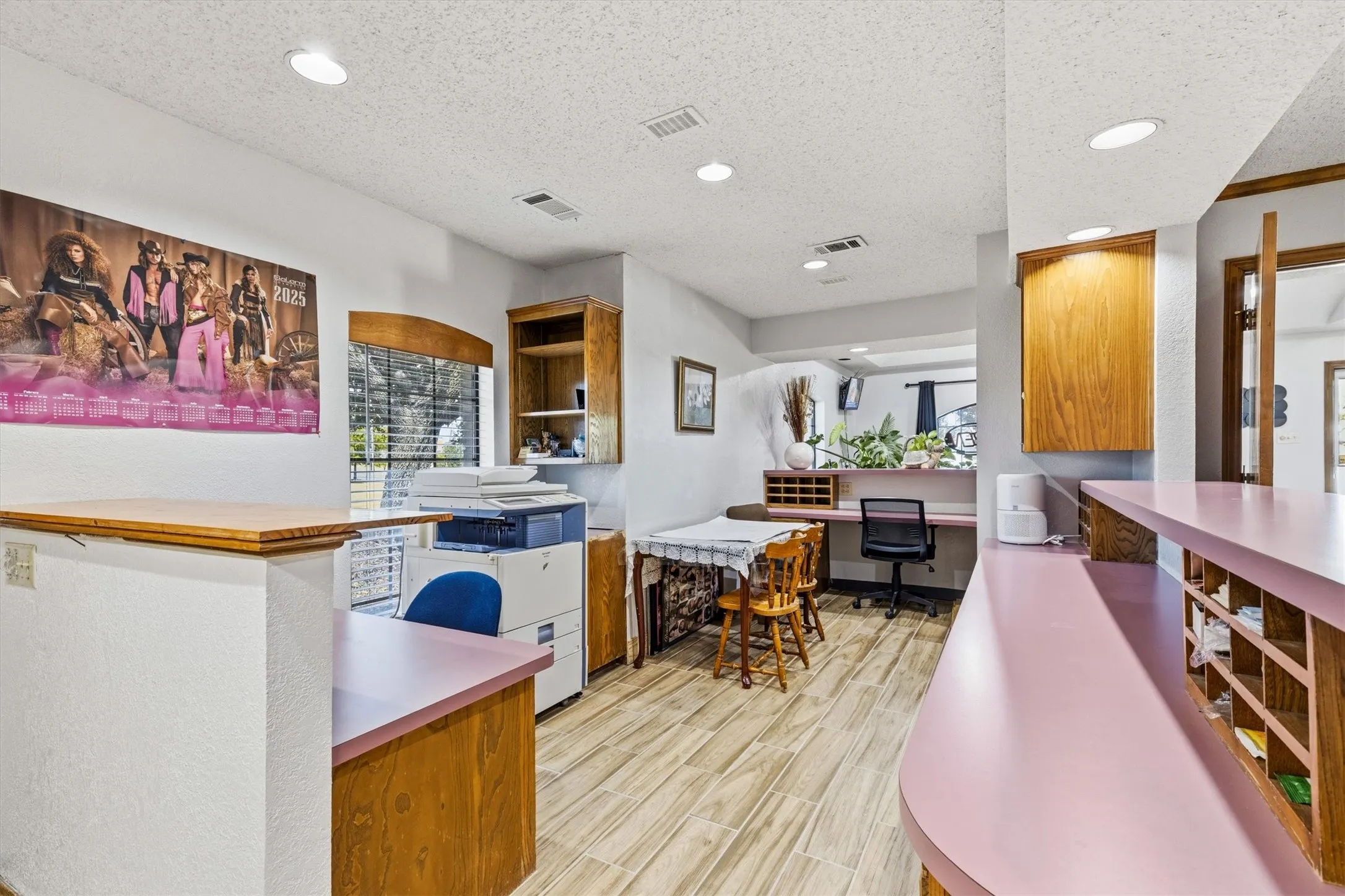 Recessed lighting, wood-finish flooring, built-in wooden cabinetry, and a countertop with integrated shelving