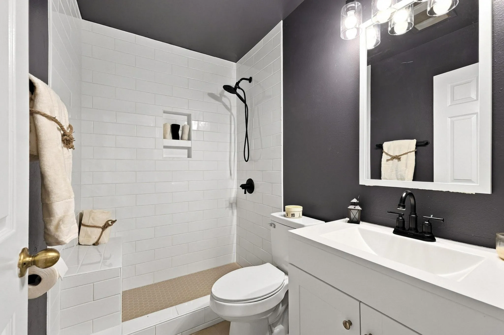 White subway tile shower with built-in niche and bench